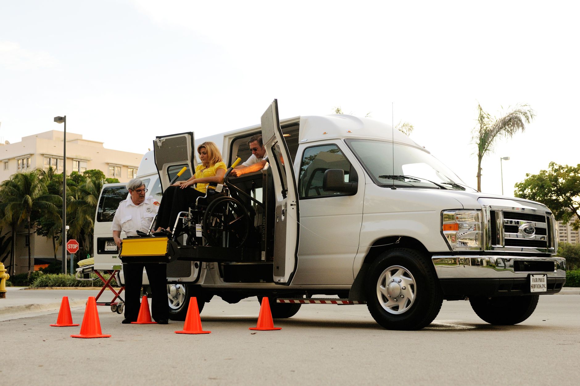 A medical transfer vehicle with a ramp at Istanbul Airport assisting a patient in a wheelchair.