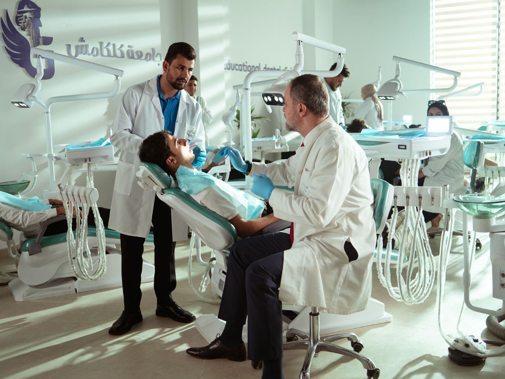 Dentist consulting a patient in a modern dental clinic with advanced equipment.