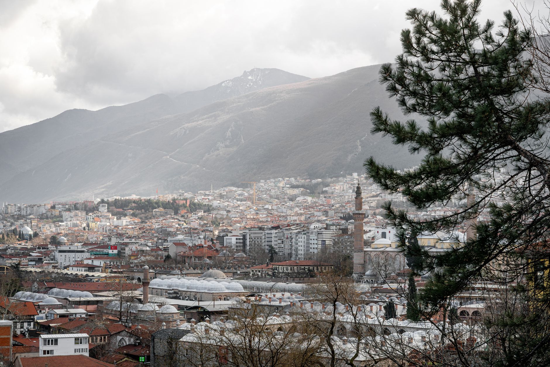A panoramic view of Bursa, highlighting its urban landscape amidst mountainous terrain.