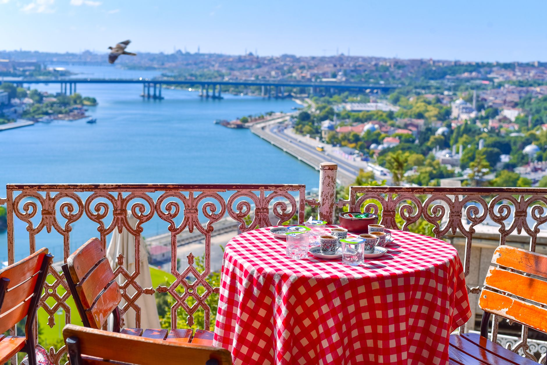 Charming terrace with a checkered table, Turkish coffee, and stunning Bosphorus scenery.
