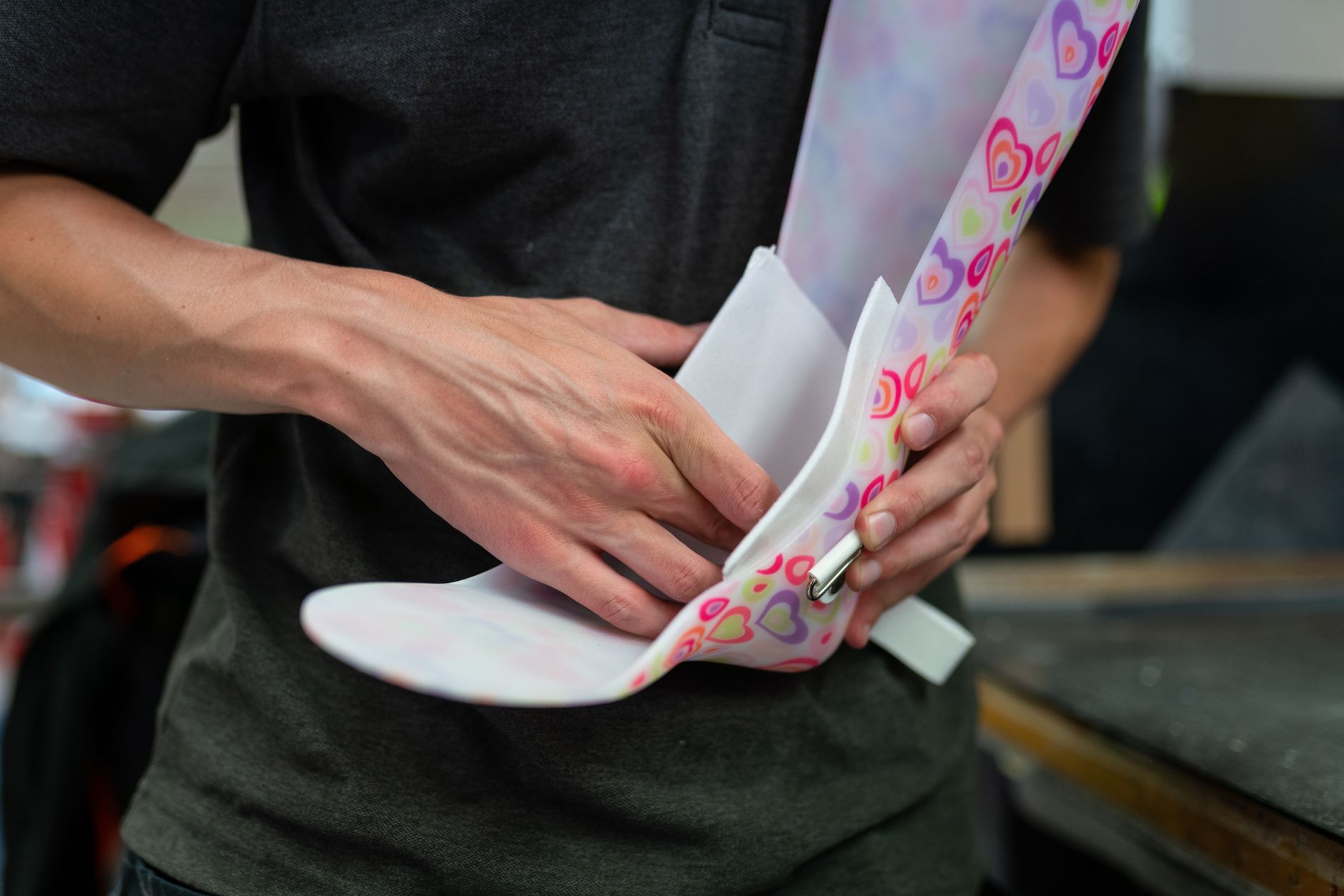 A person fitting a colorful thermoplastic splint on a wrist, ensuring proper alignment.