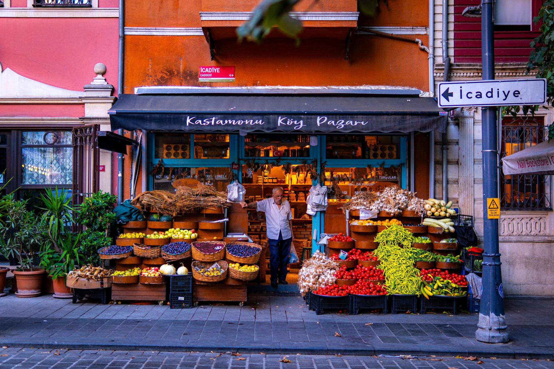 Colorful market stall in Istanbul featuring fresh fruits, vegetables, and spices.