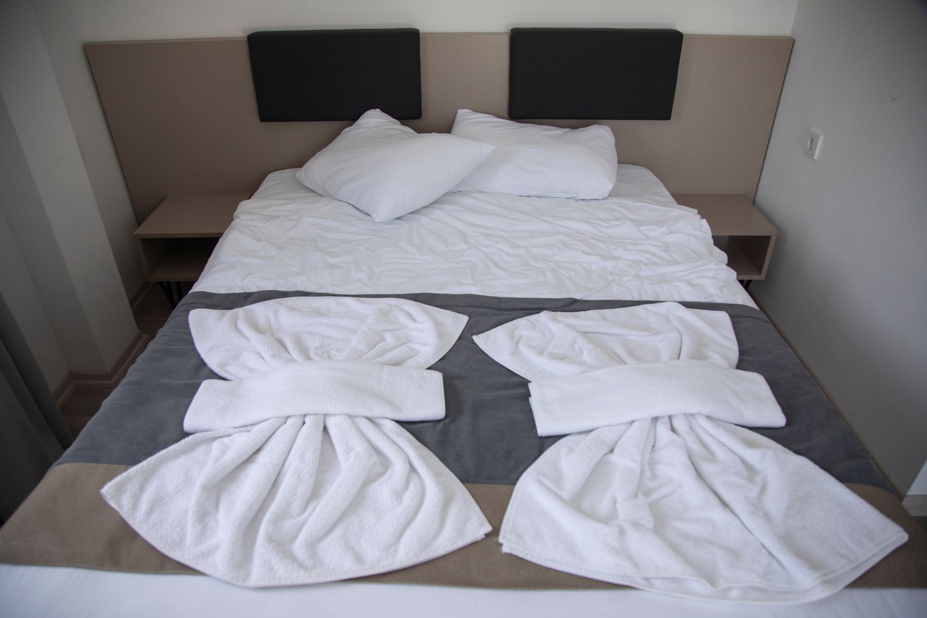 A neatly made bed in a hotel room in Istanbul, ideal for medical travelers and companions.