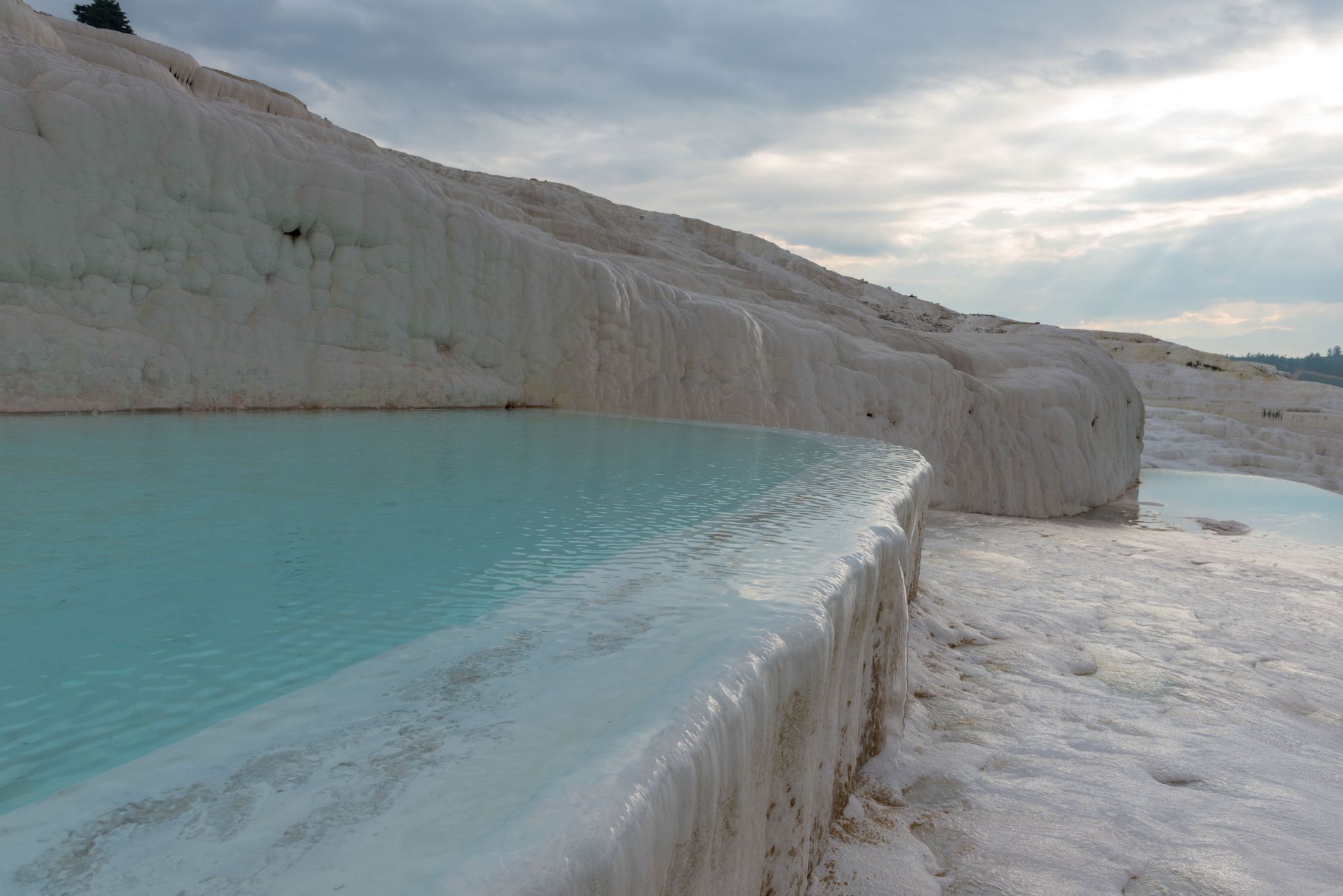 Stunning Pamukkale thermal pools with turquoise waters and white travertine terraces in Türkiye.