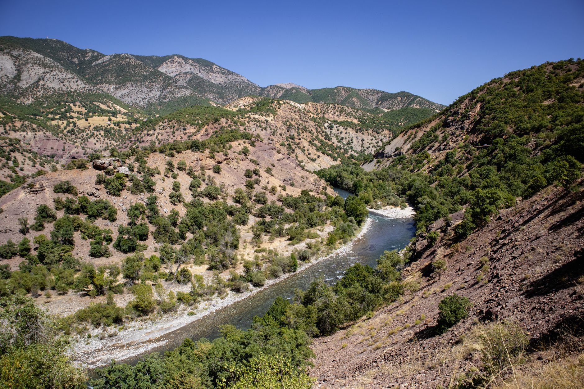 Scenic landscape of Munzur Çayı and valley with mountains and greenery.