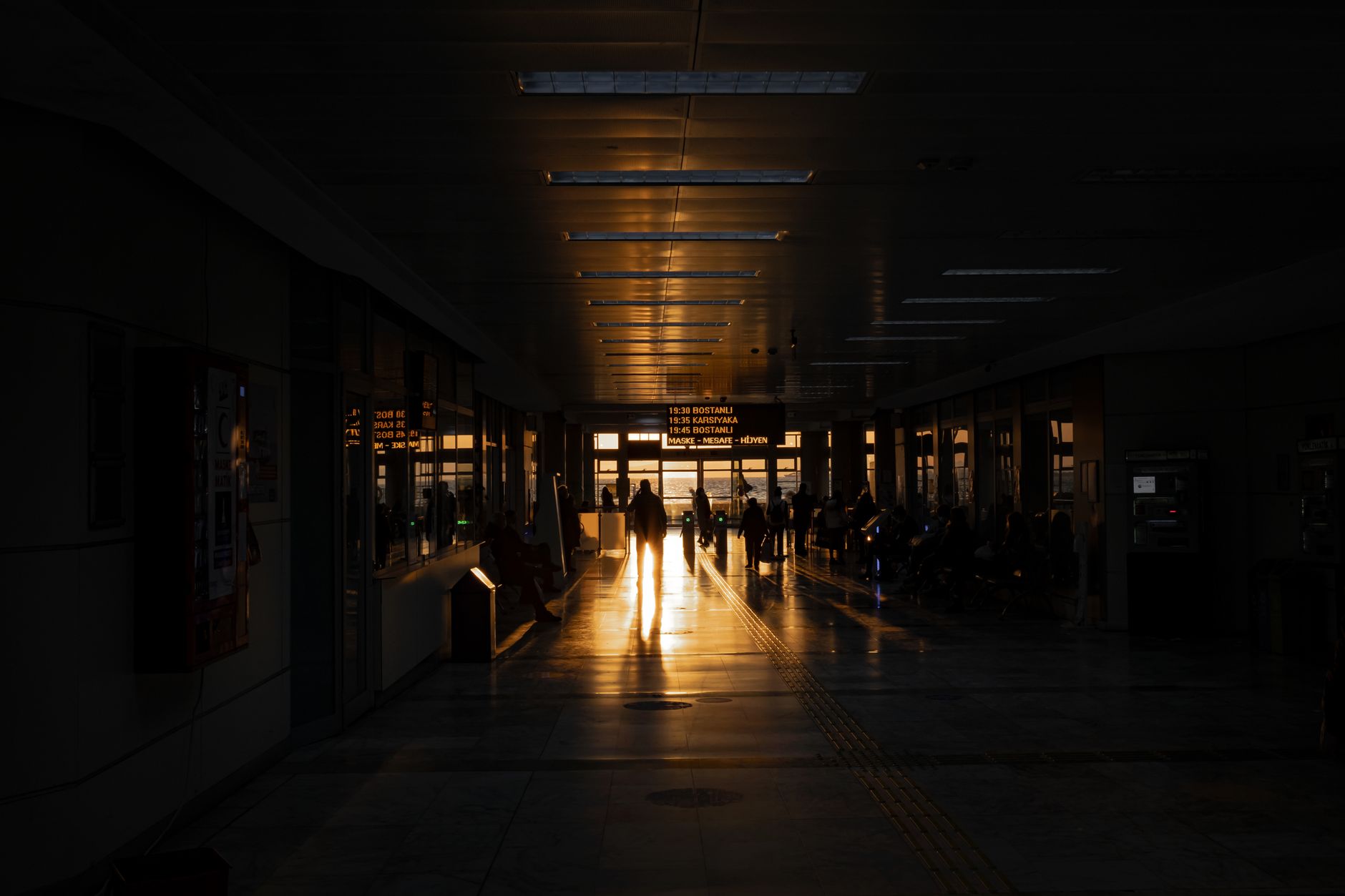 View of the modern terminal interior at Izmir Airport, illuminated by sunset.