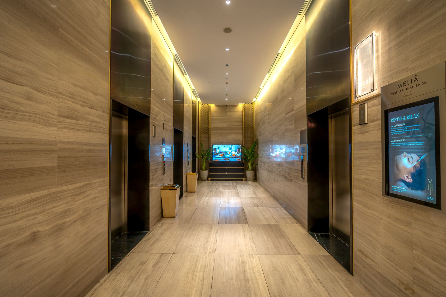 Interior view of the modern lobby with elevators and spa display at Meliá VinPearl Thanh Hoa.