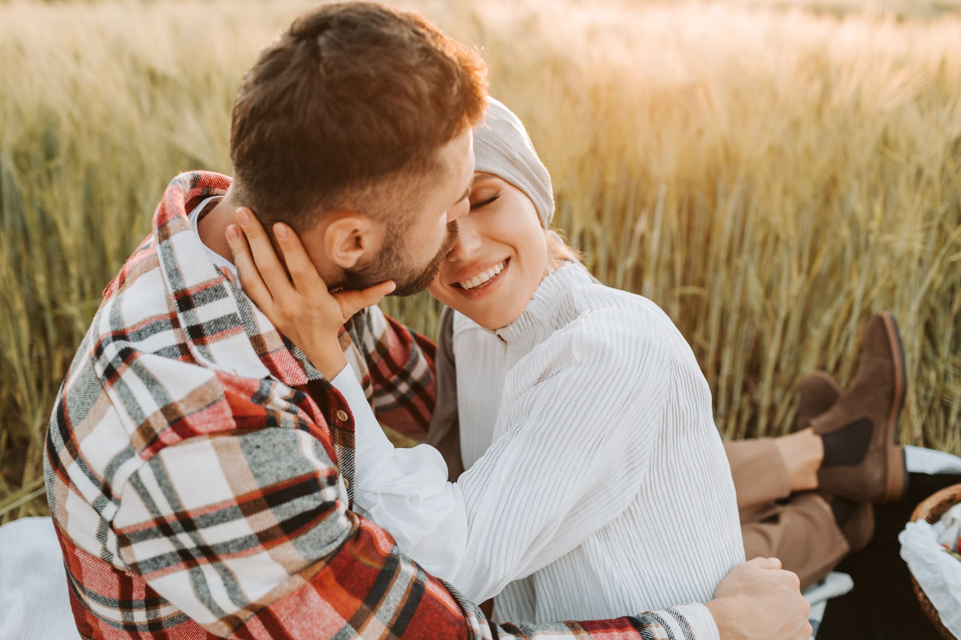 A joyful couple embracing in a wheat field, celebrating gratitude and recovery in Türkiye.