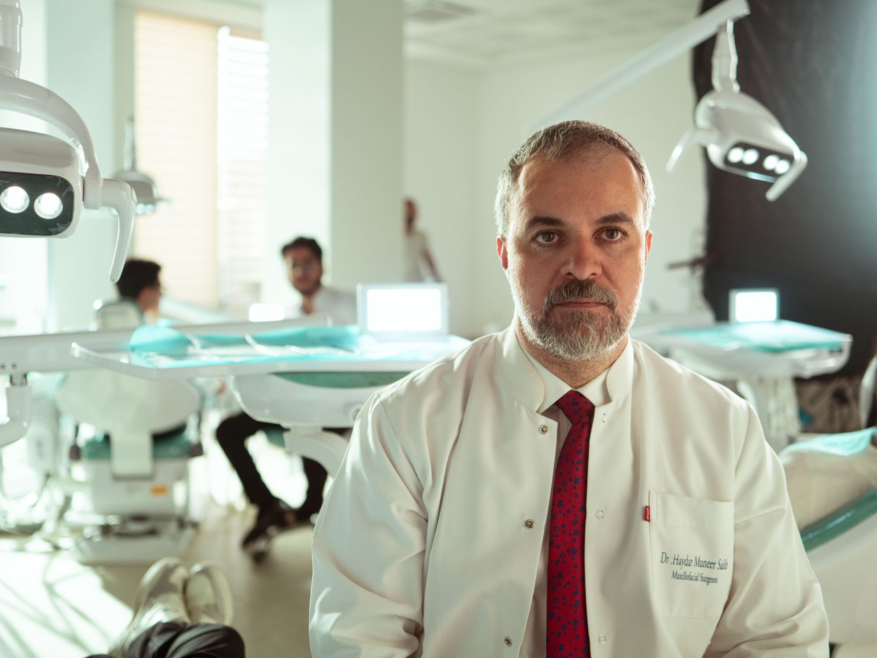 Dr. Haydar Mucenser, a maxillofacial surgeon, in a contemporary Antalya dental clinic.