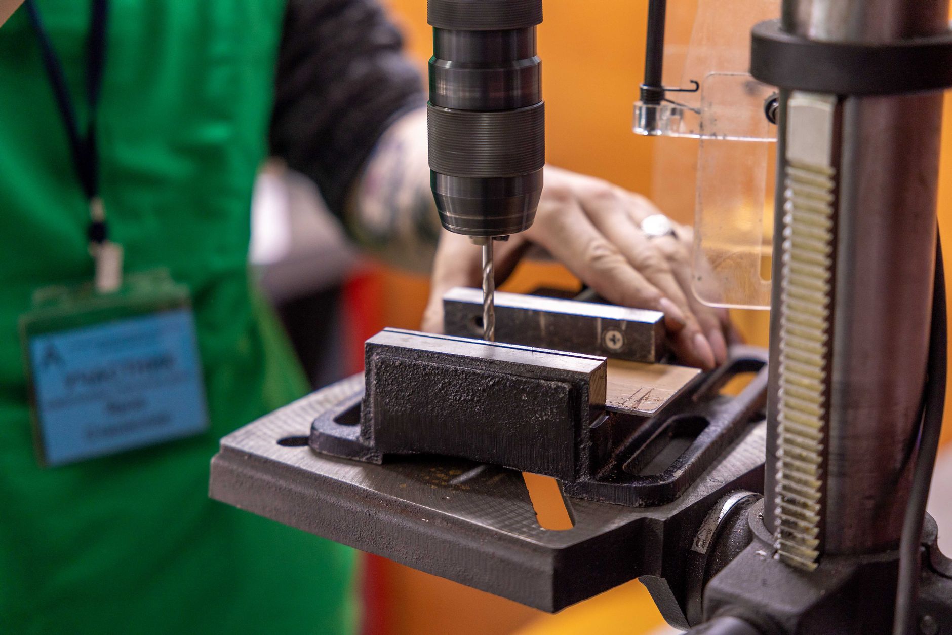 A close-up of a drill being used on a workbench, showcasing precision engineering.