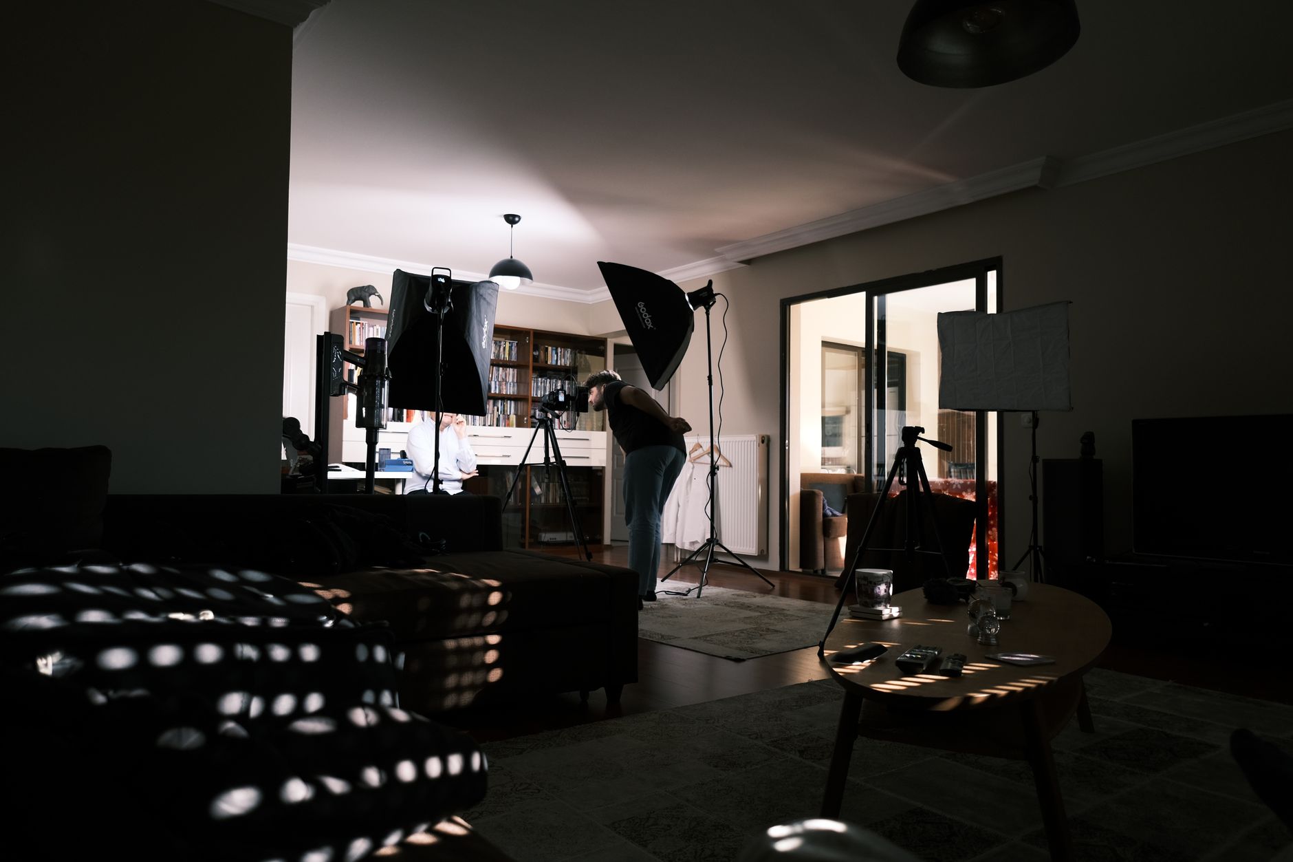 A living room with a patient preparing for peritoneal dialysis, supplies organized nearby.