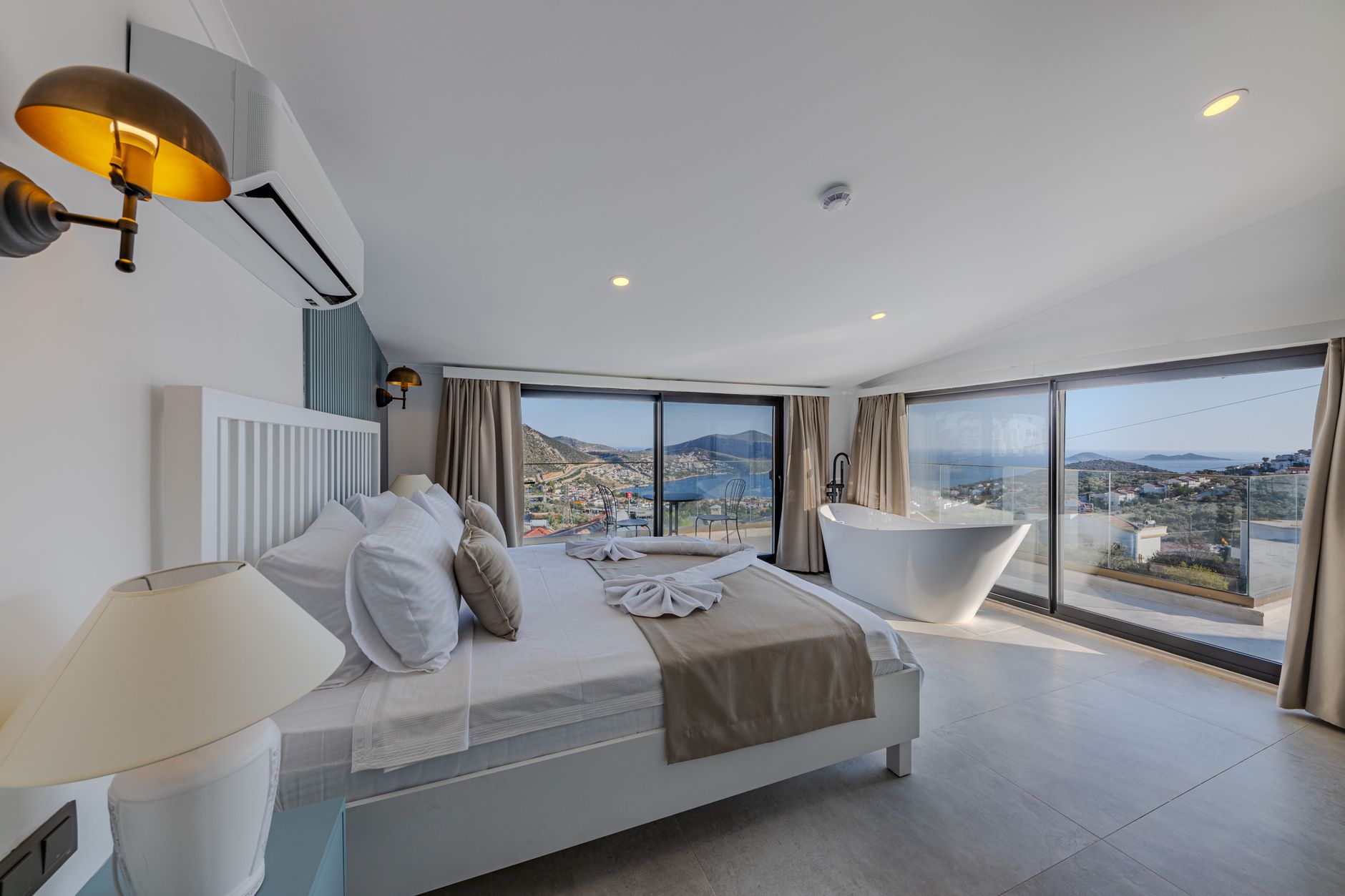Spacious hotel room with a sea view, modern decor, and comfortable amenities.