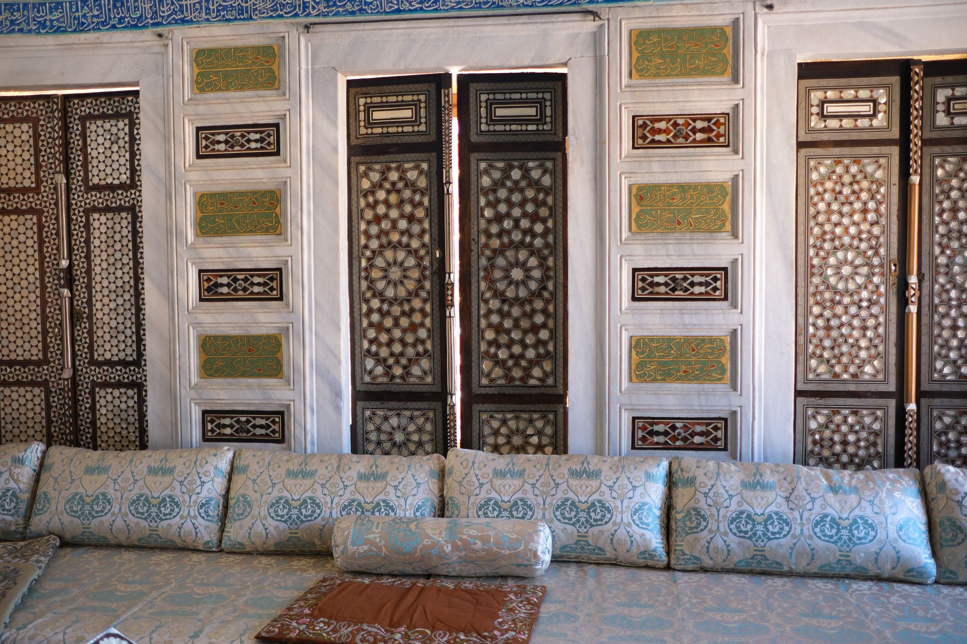 Interior of a Turkish hospital room featuring ornate doors and comfortable seating.