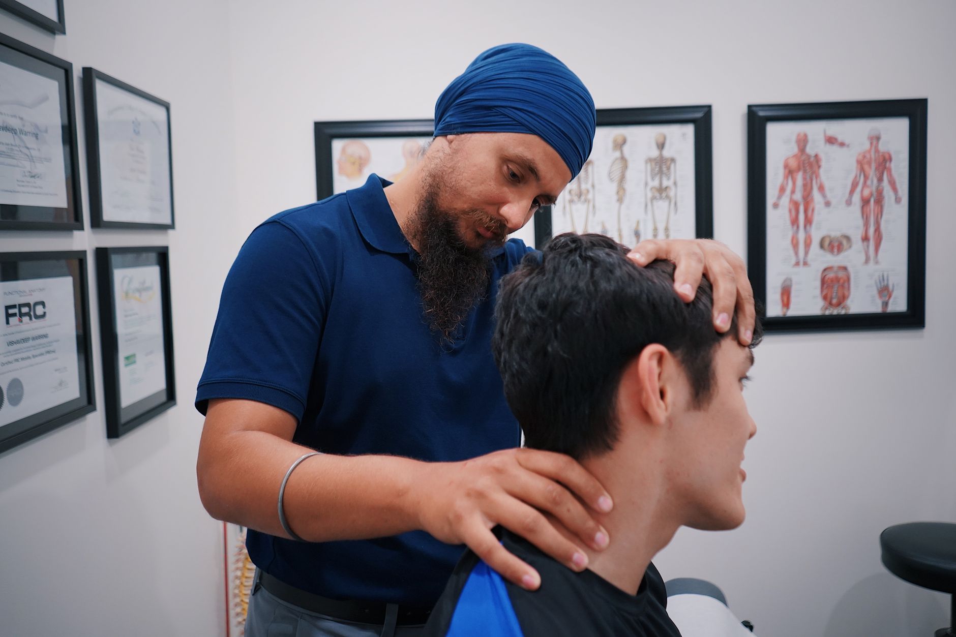 A physiotherapist assists a patient with jaw exercises in a clinic setting.