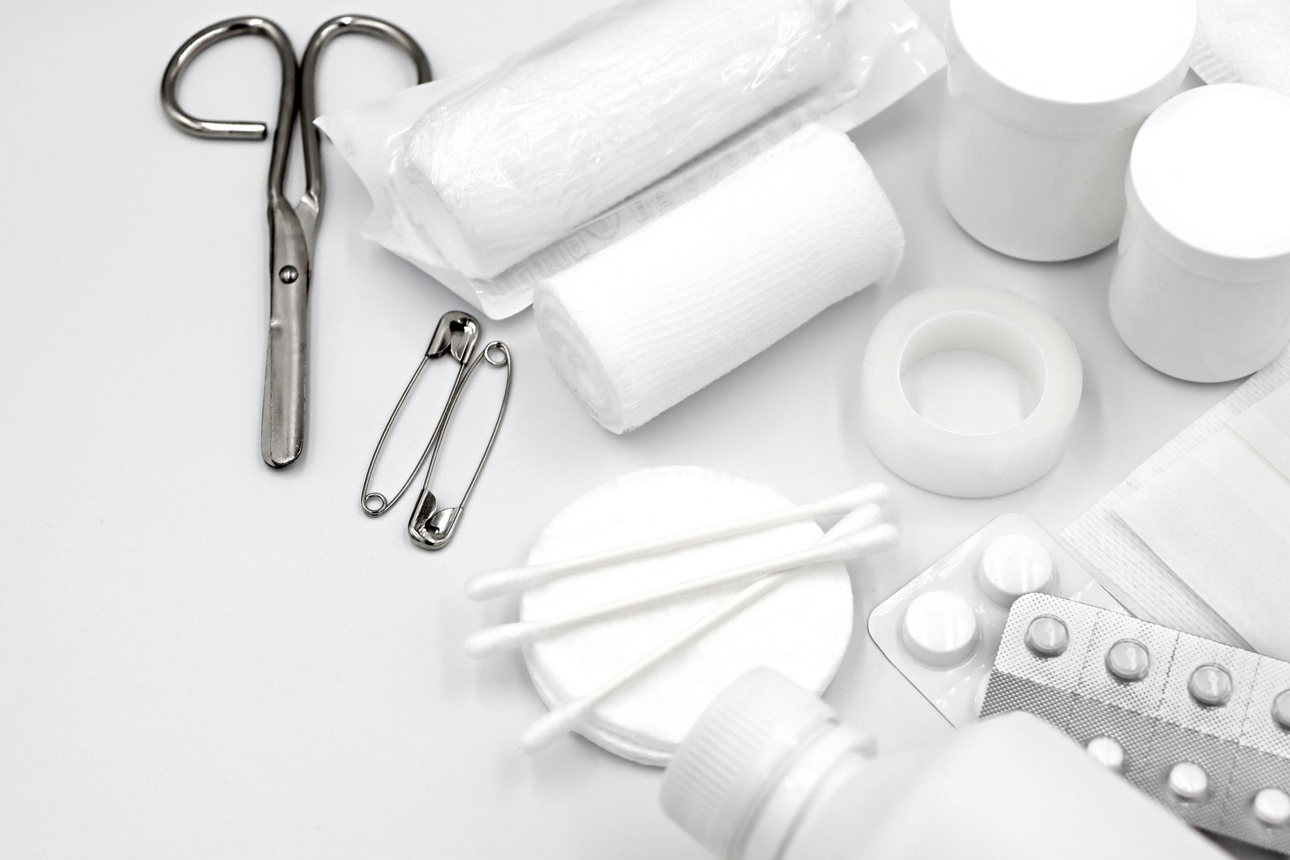 Sterile gauze, dressings, saline, and tape in a take-home kit.