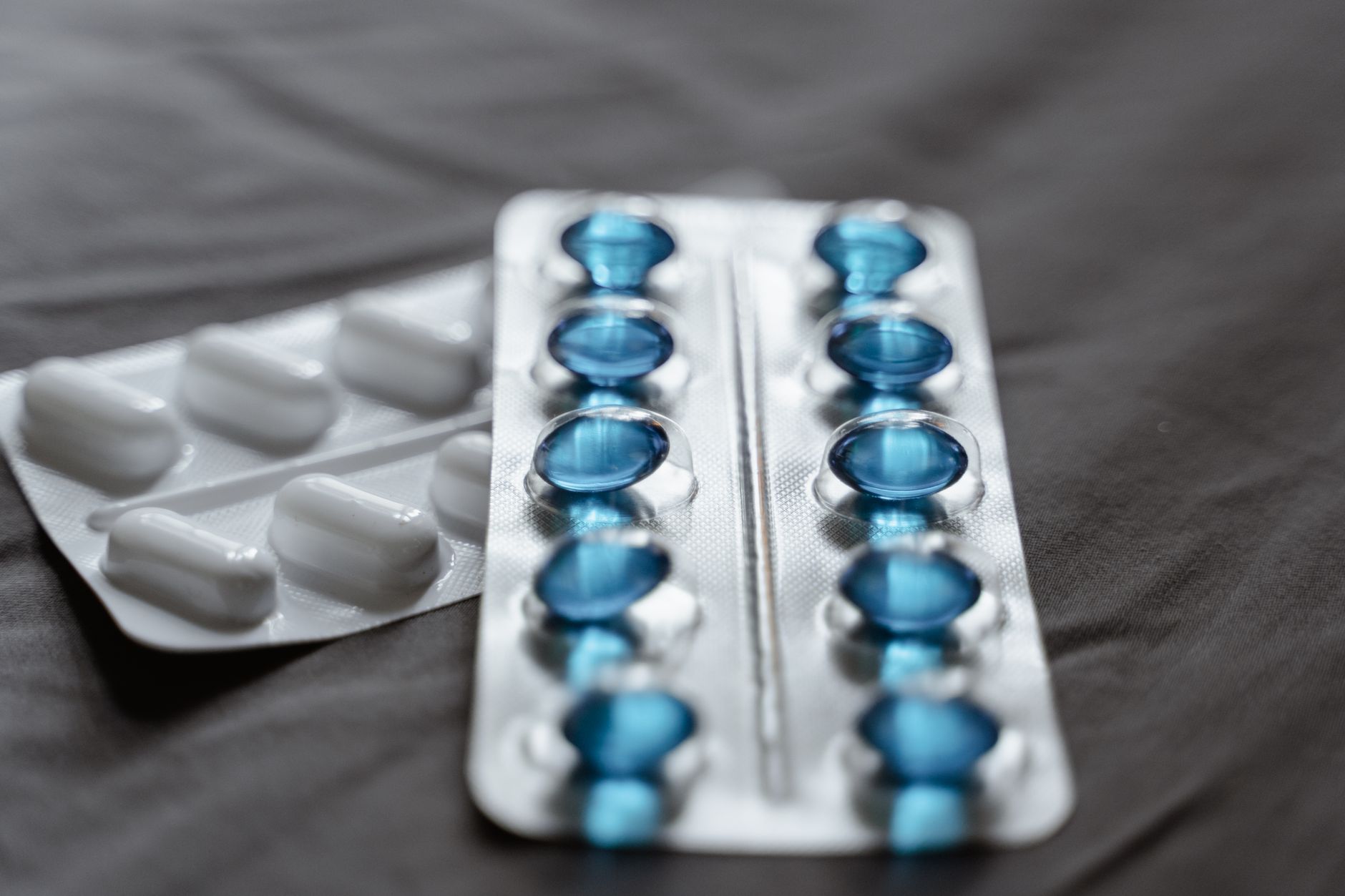 Close-up of blue medication capsules in packaging, ideal for medical travel.