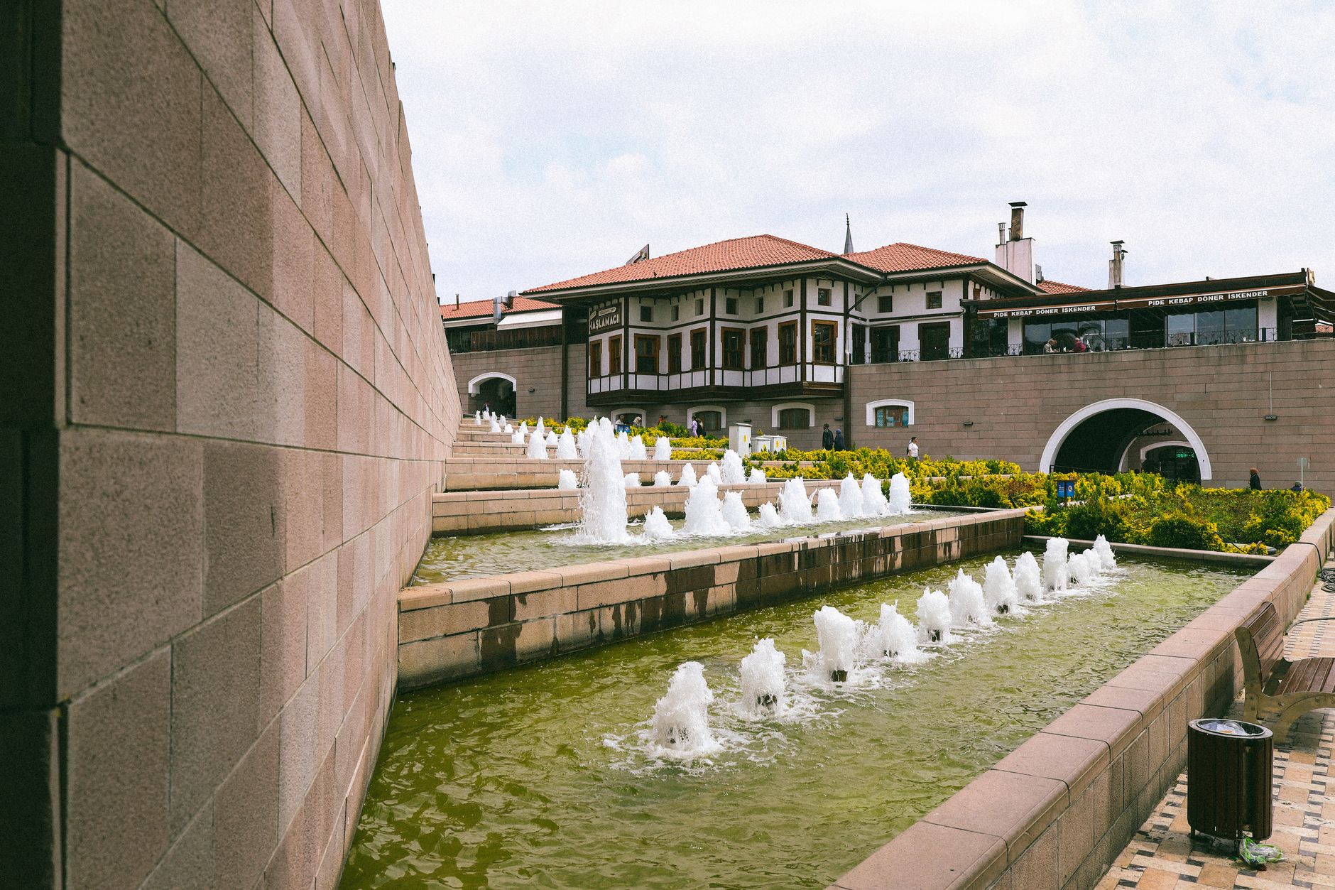 Families enjoying the scenic Gençlik Park in Ankara, featuring beautiful fountains and lush greenery.