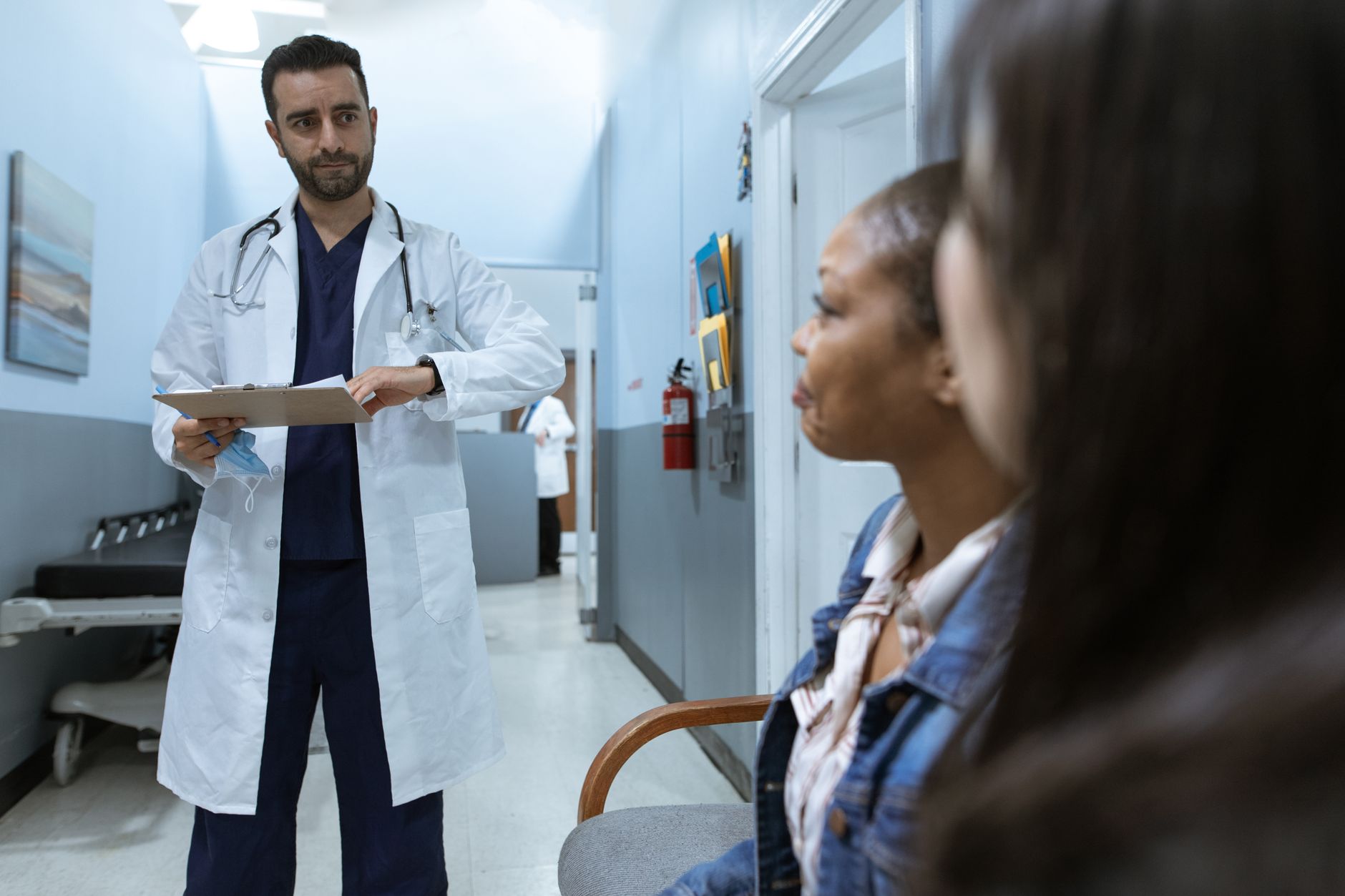 A urologist discusses a medical case with a patient in a hospital setting.