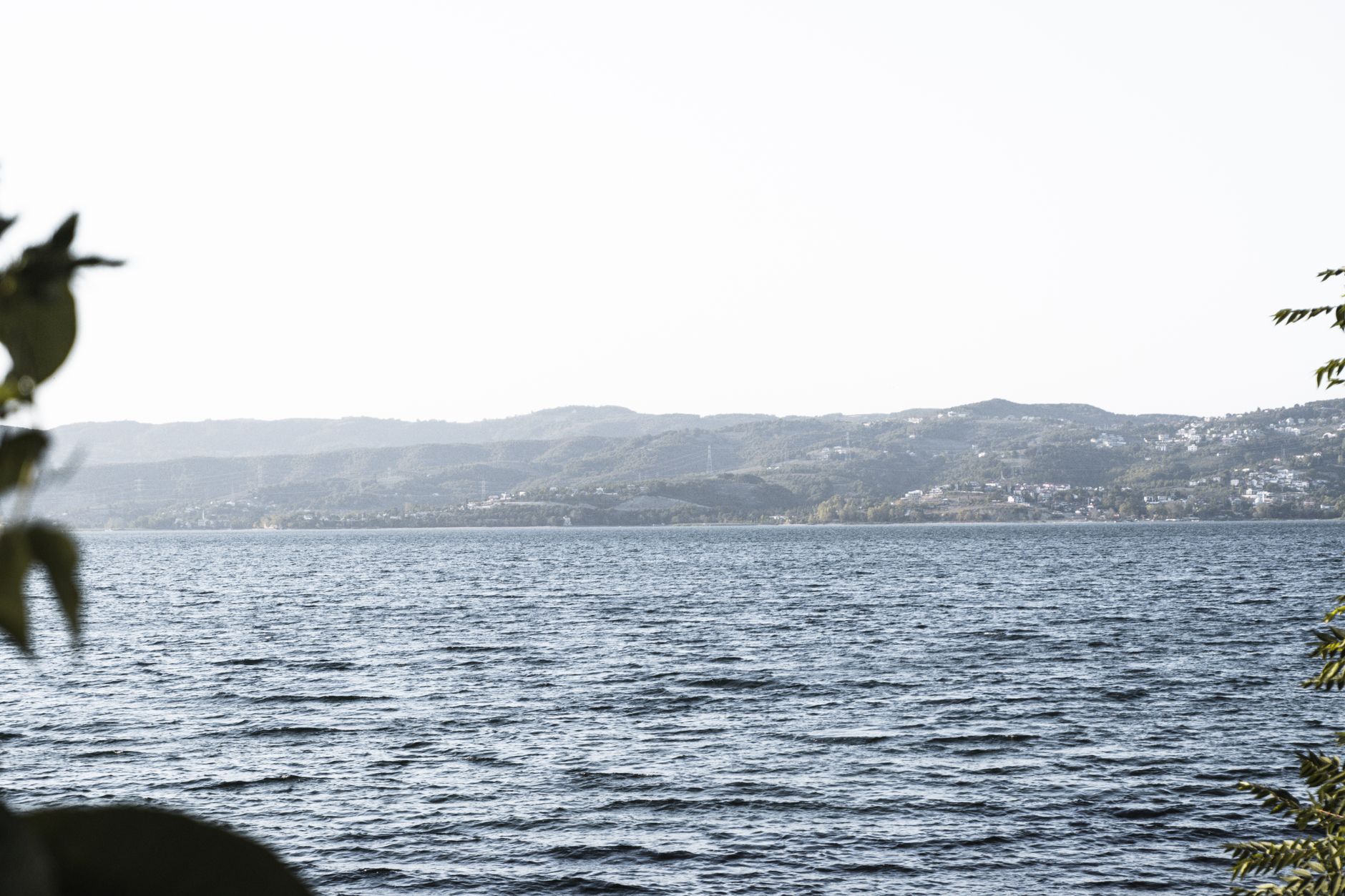 View of the calm waters of Lake Sapanca surrounded by lush hills.