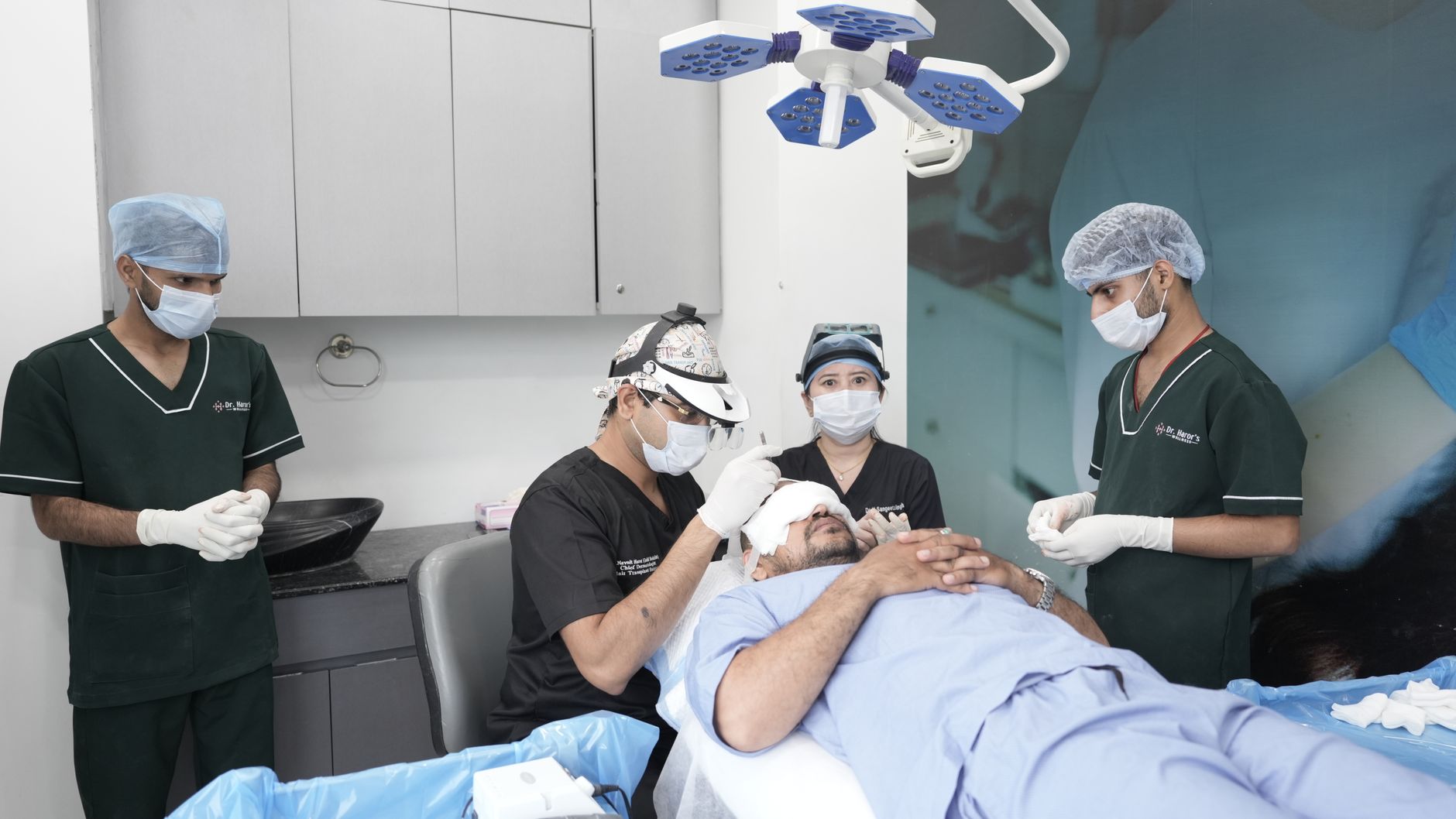 Medical team performing a hair transplant procedure on a patient.