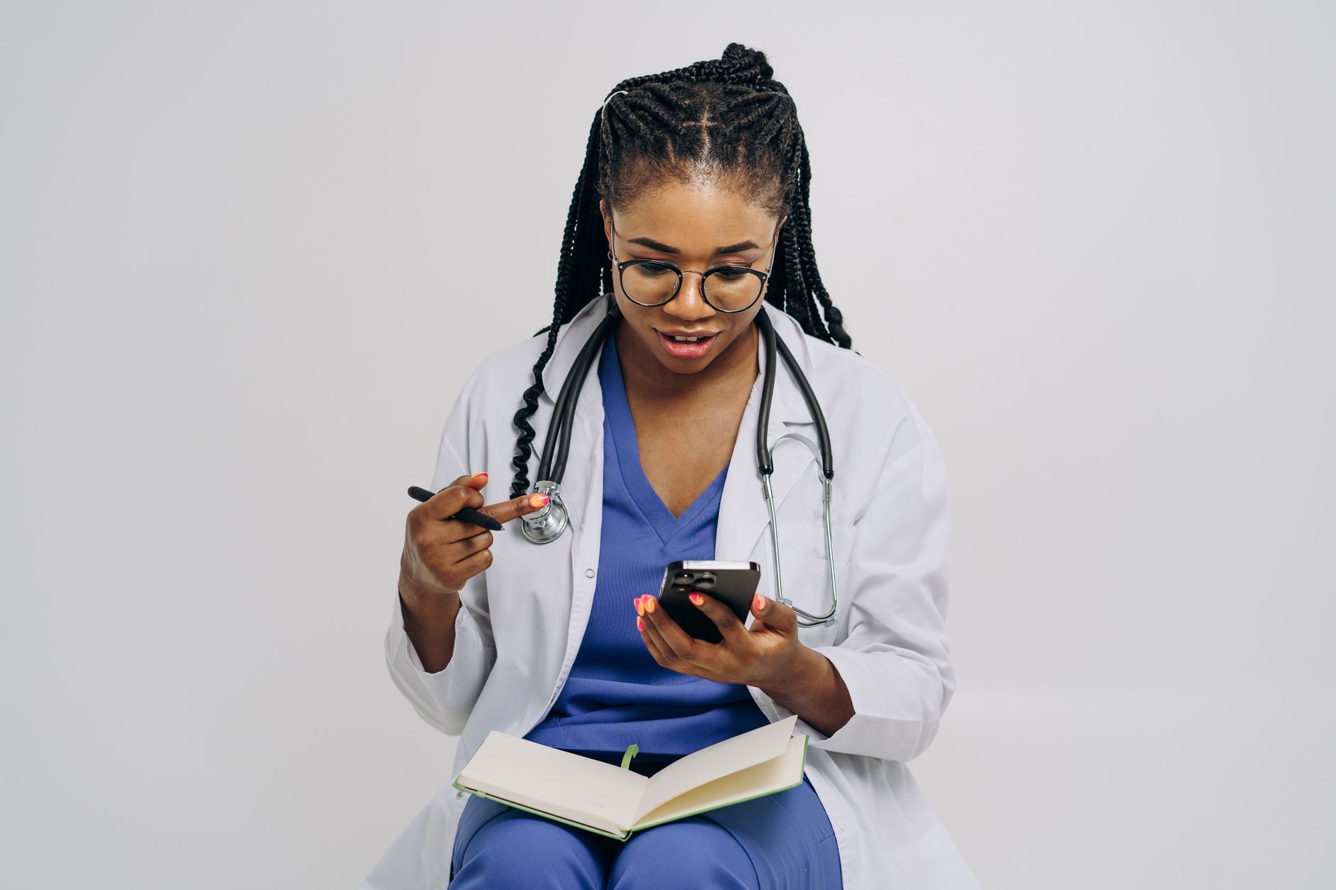 A doctor with glasses checks reviews on a smartphone, highlighting patient feedback importance.