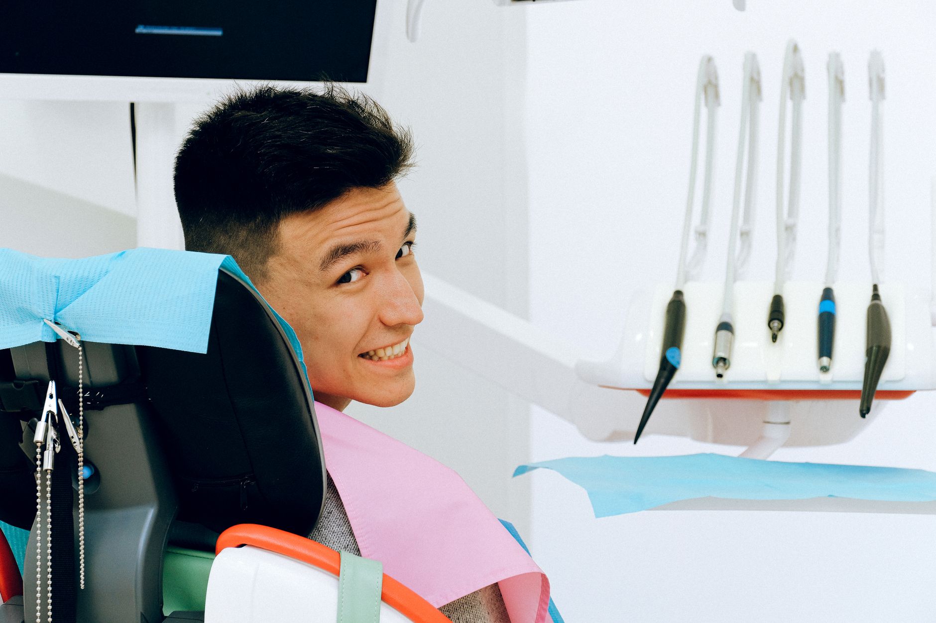 A satisfied dental patient smiling while seated in a dental chair in Türkiye.