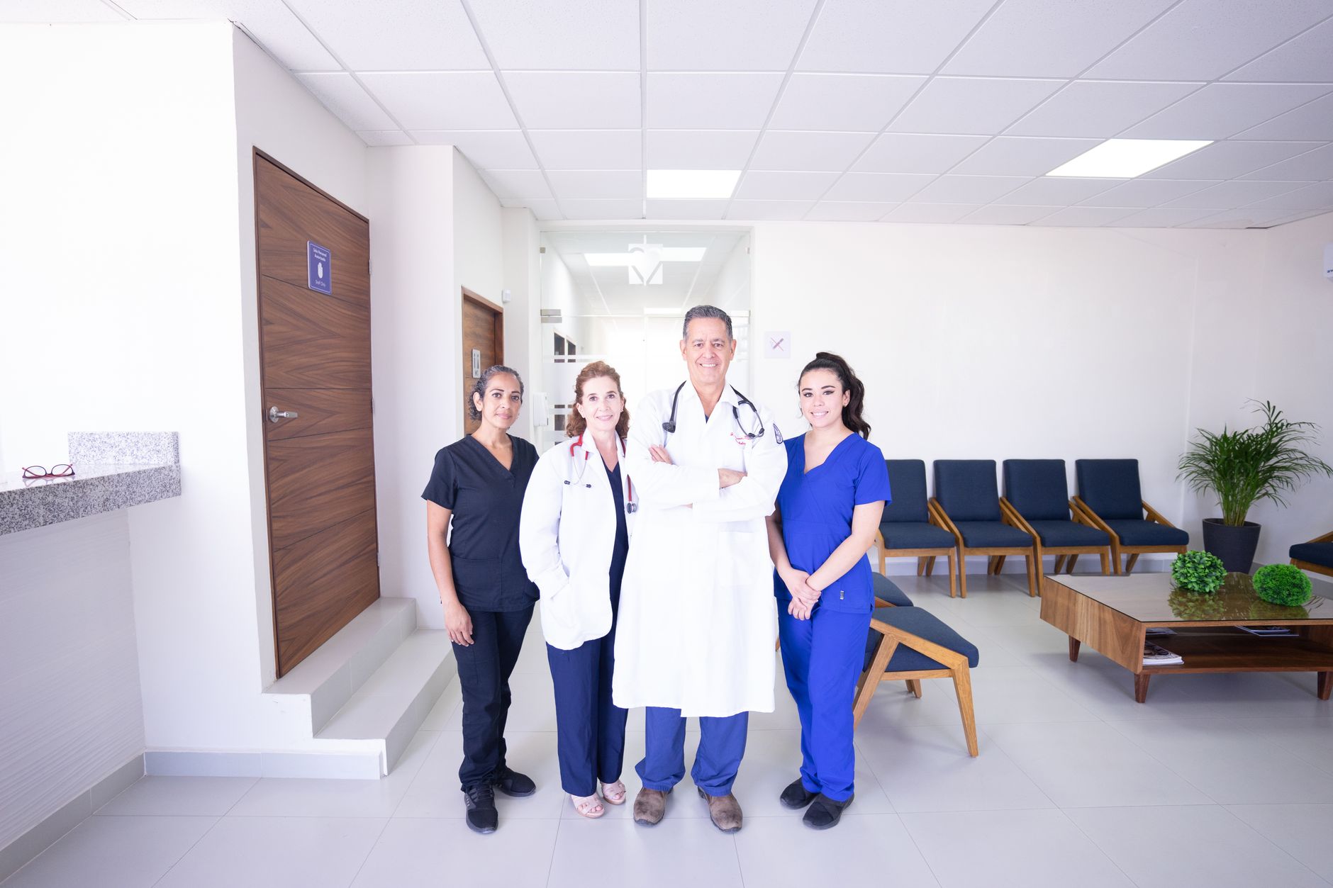 A diverse medical team in a Turkish hospital, including doctors and therapists, smiling and posing together.