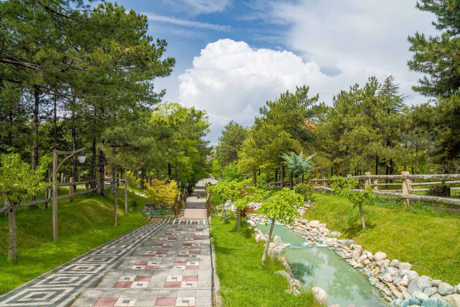 A tranquil walkway in Seka Park, lined with trees and greenery, ideal for relaxation.
