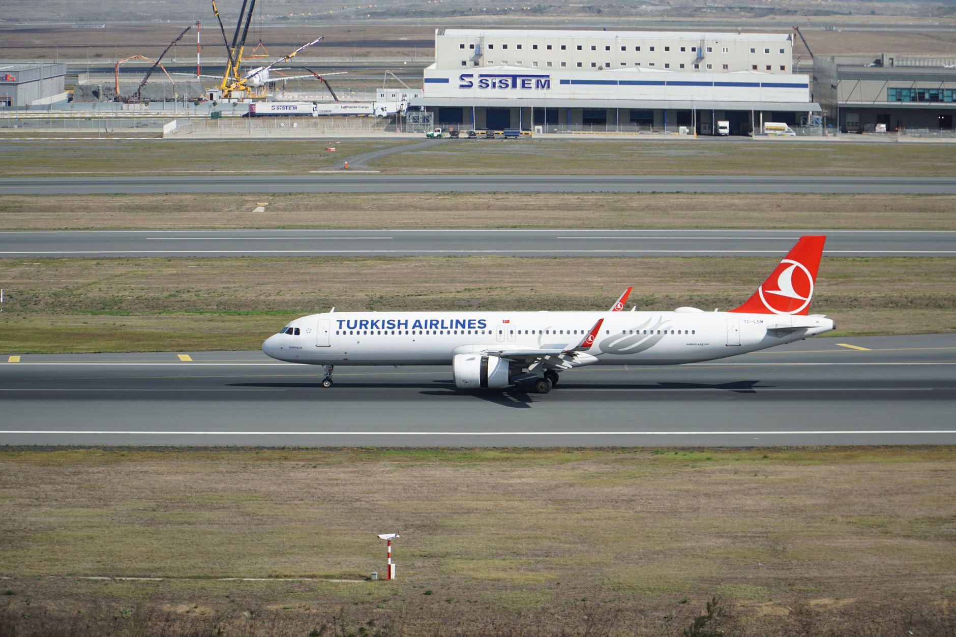 A Turkish Airlines plane taxiing at Istanbul Airport, heading to a domestic gate.