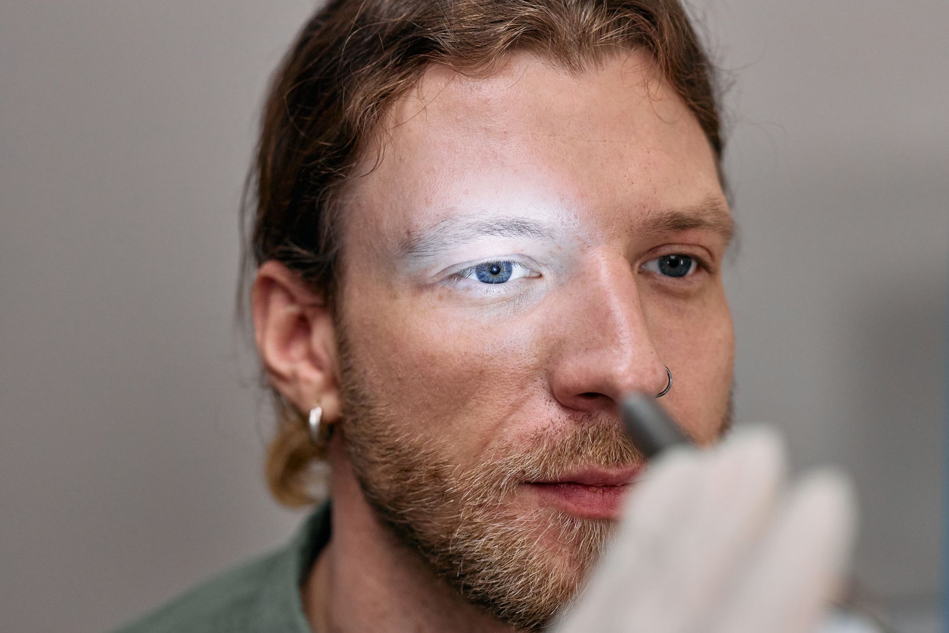 Close-up of a male patient during an eye examination with a light.