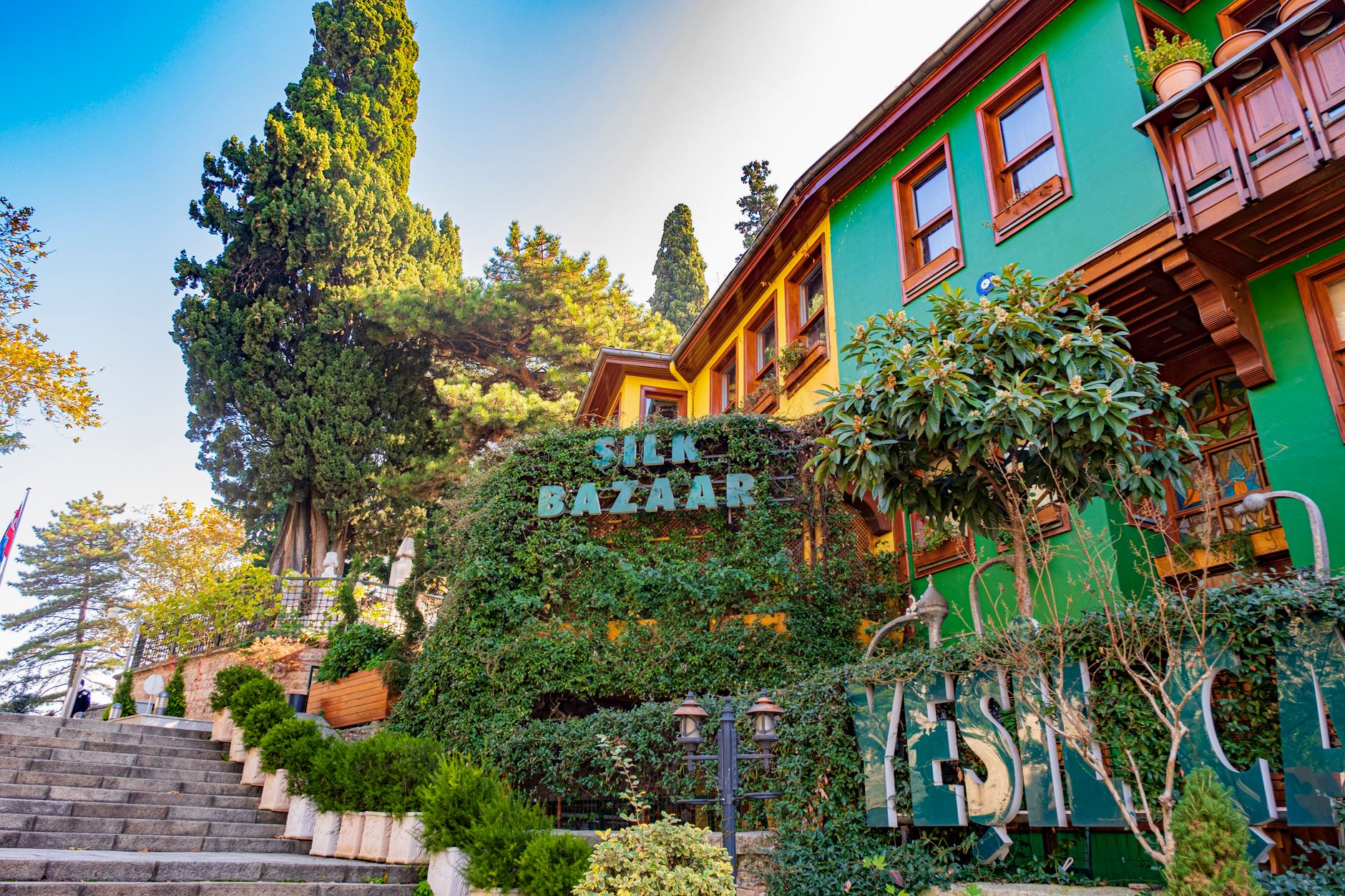 Vibrant view of the Silk Bazaar in Bursa, adorned with greenery and colorful architecture.