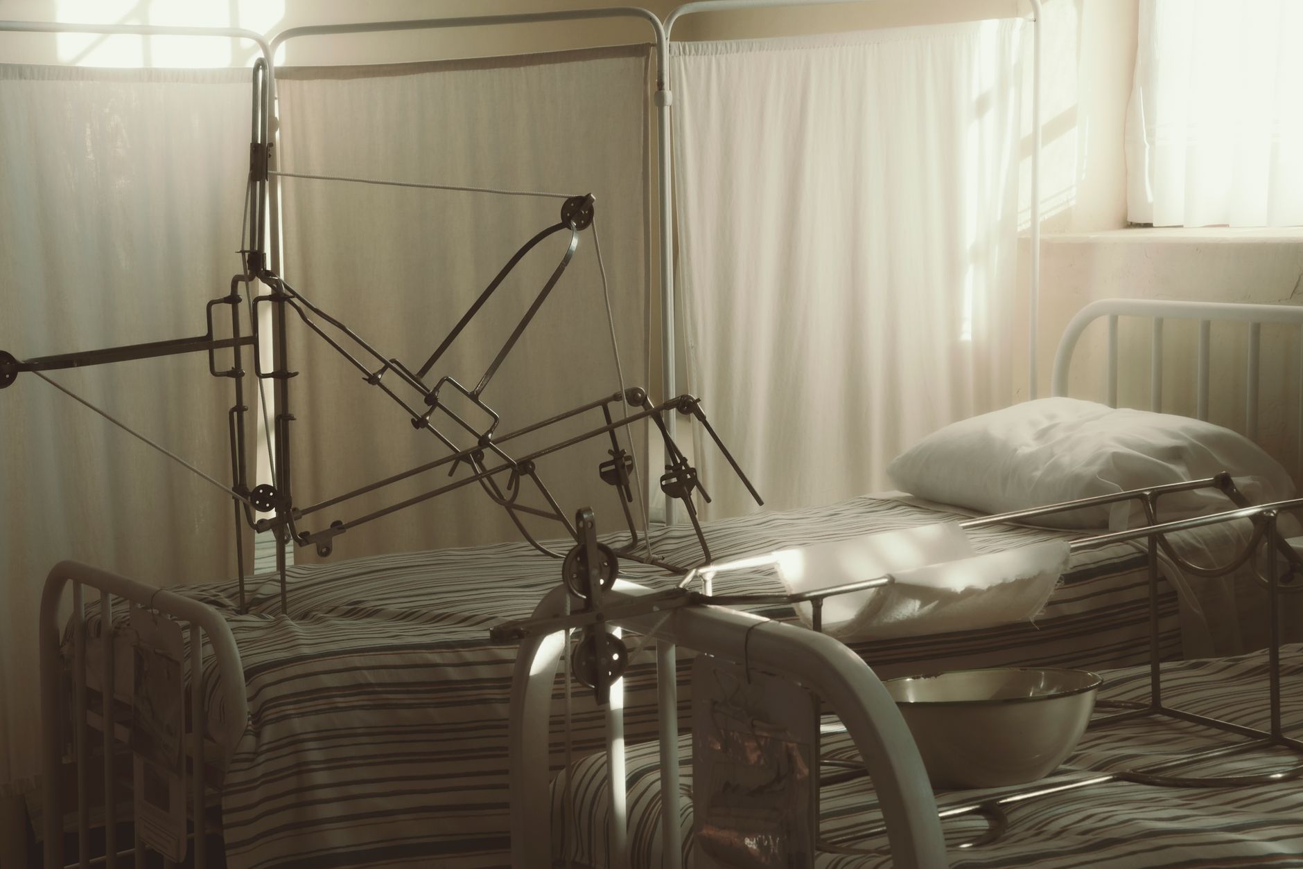 A well-lit urology recovery room with hospital beds and medical equipment.
