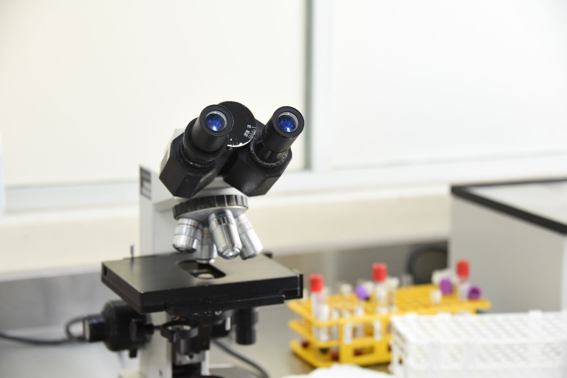 Close-up of a microscope used for examining biopsy samples in a lab.