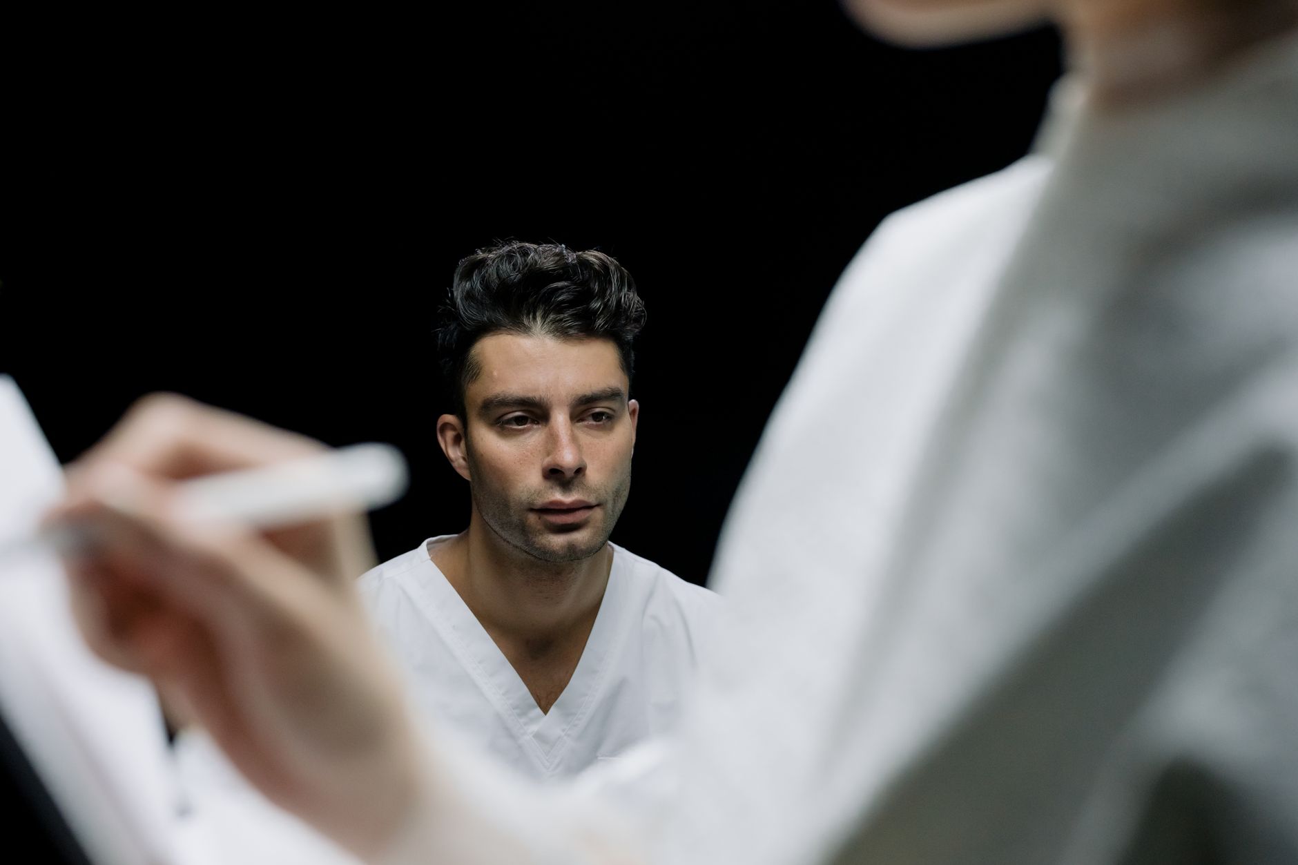 A patient discusses hairline options with a surgeon during a consultation.