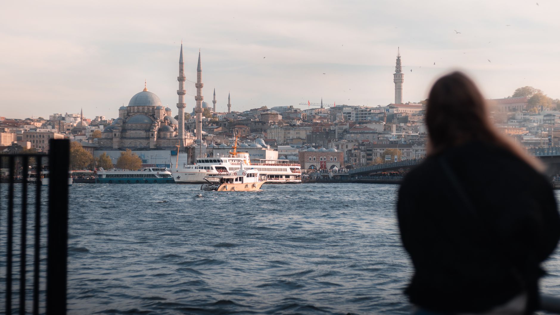 View of Istanbul's skyline with a ferry on the Bosphorus, capturing the city's historic beauty.
