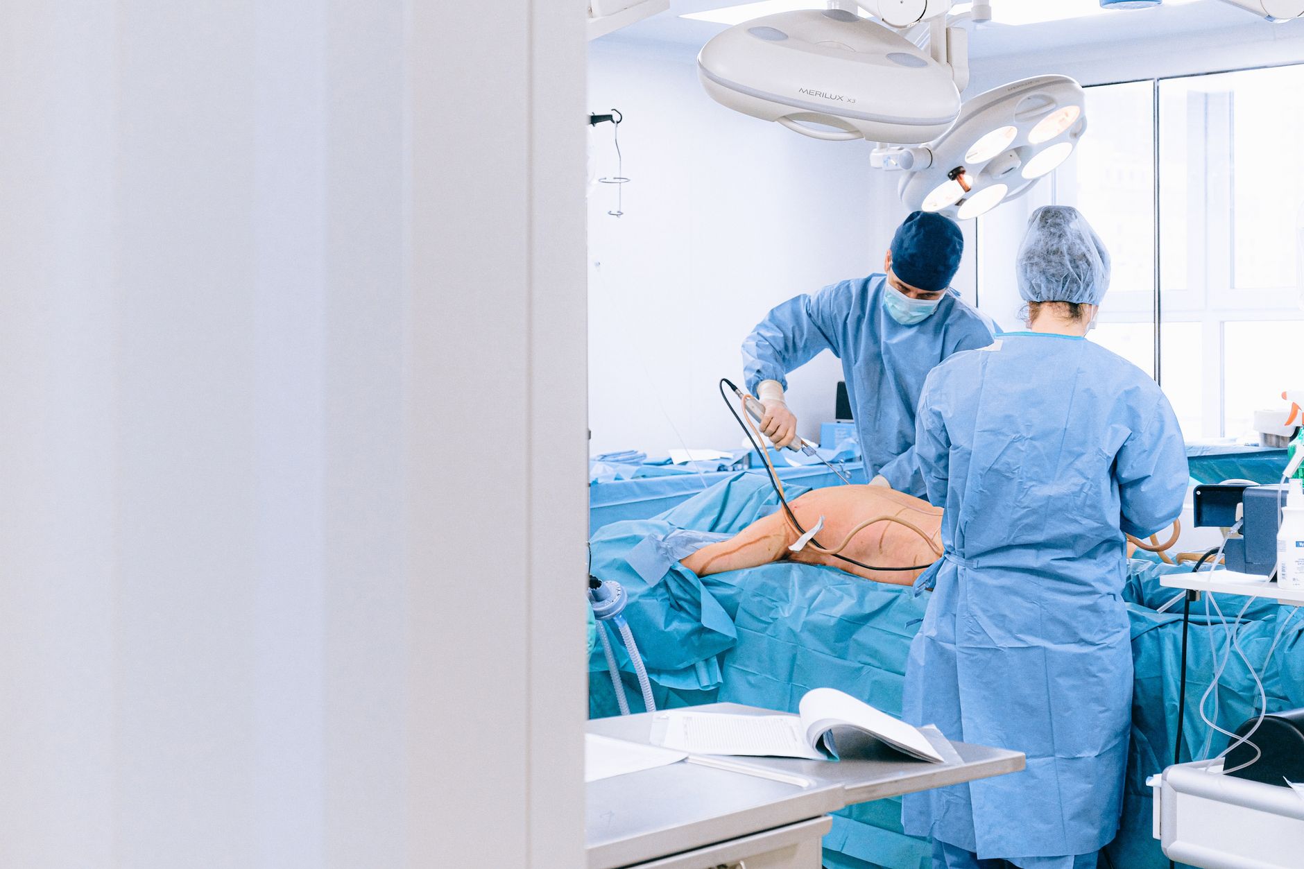 Surgeons performing arthroscopic shoulder surgery in a surgical setting.