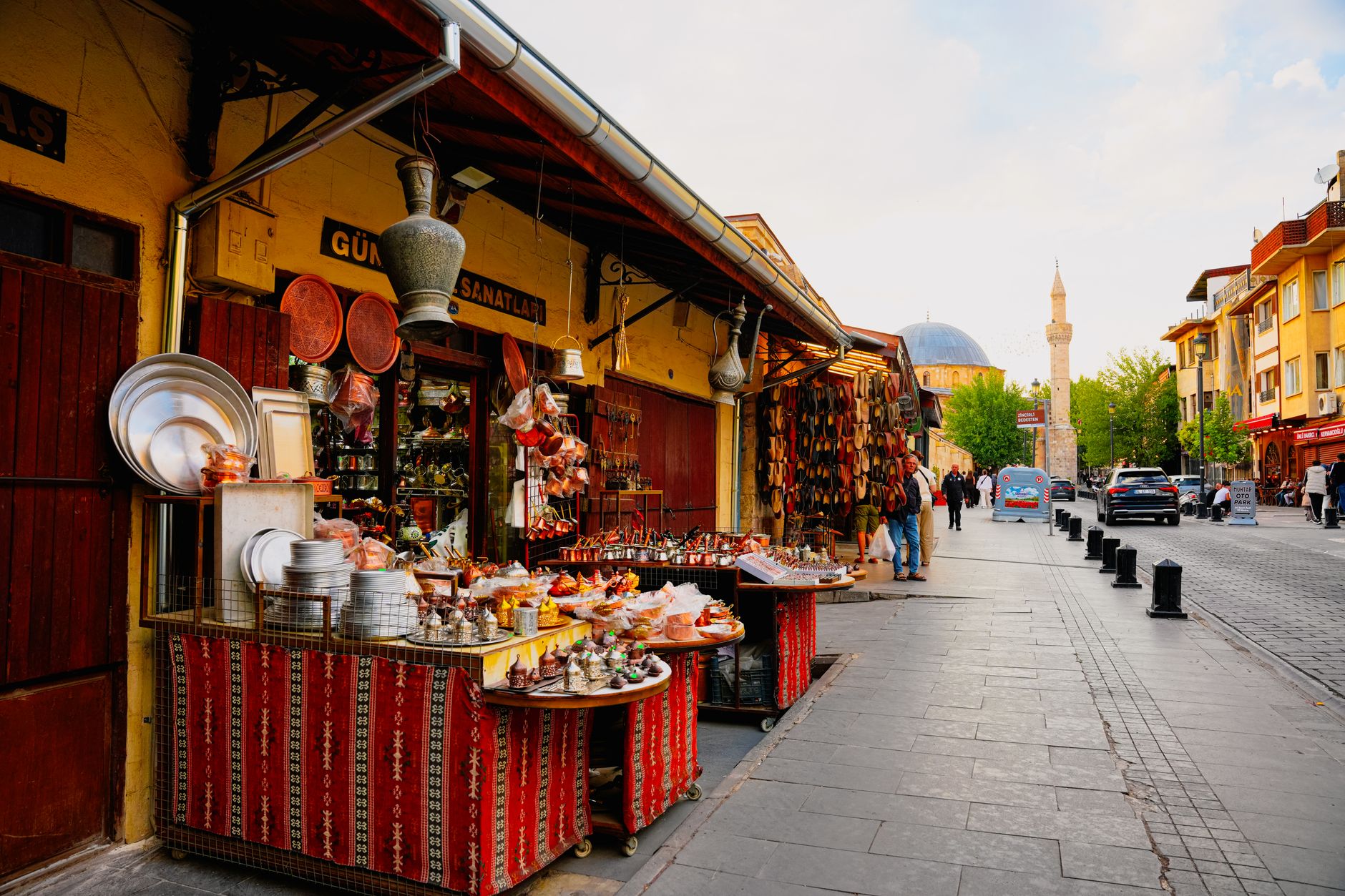 Vibrant street view of Gaziantep bazaar showcasing colorful pottery and handicrafts.