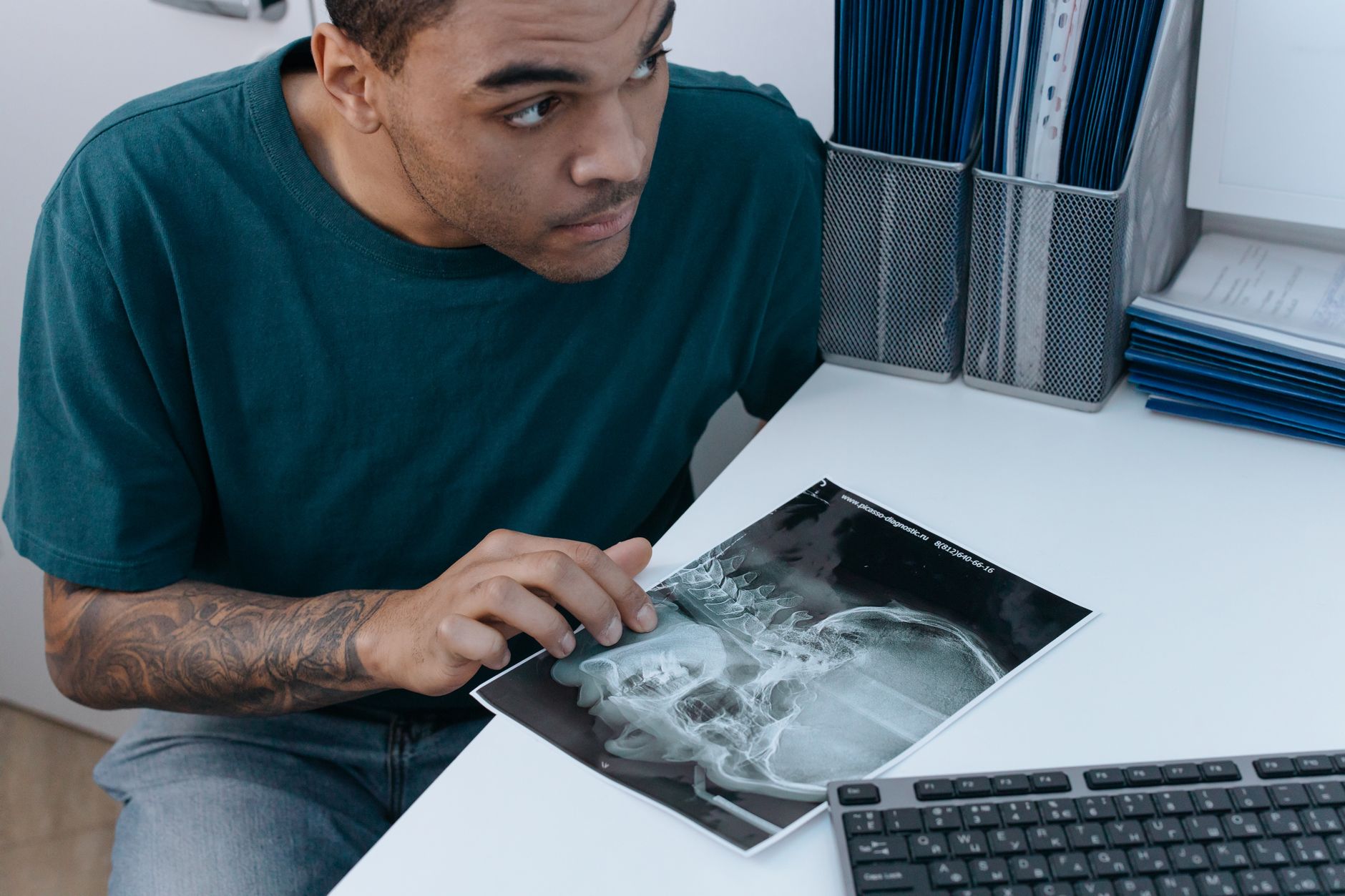 Individual examining an X-ray of jaw, discussing airway advancement options.