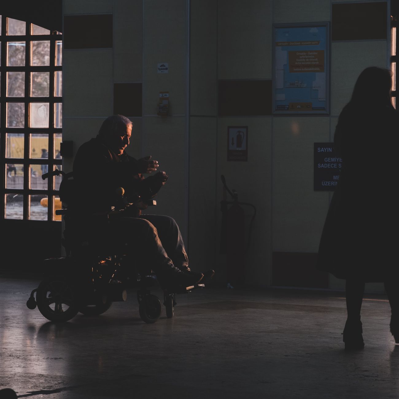 A patient in a wheelchair engaged in rehabilitation exercises at a Turkish hospital.