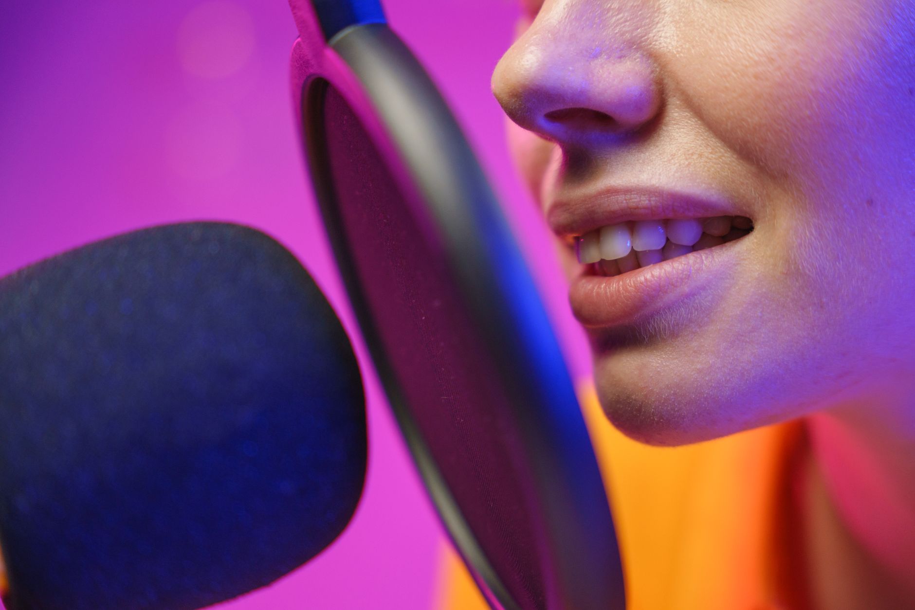 Close-up of a person speaking into a microphone during a voice check.