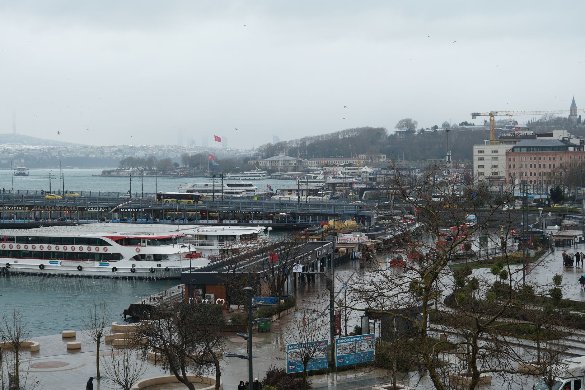 A tranquil view of the Bosphorus in Istanbul, featuring boats and cloudy skies.
