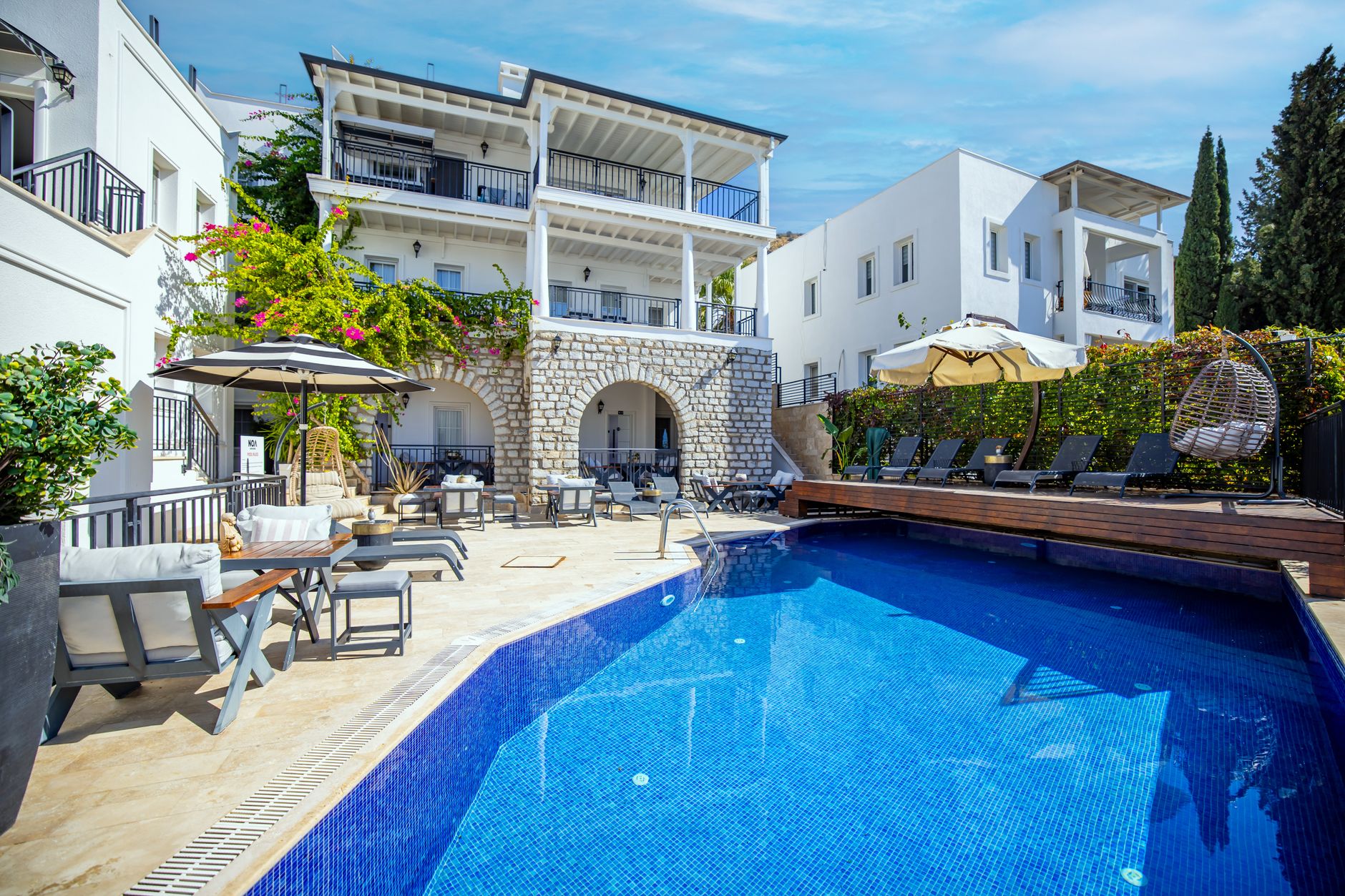 Inviting hotel pool area in Bodrum with luxurious seating and relaxing vibe.