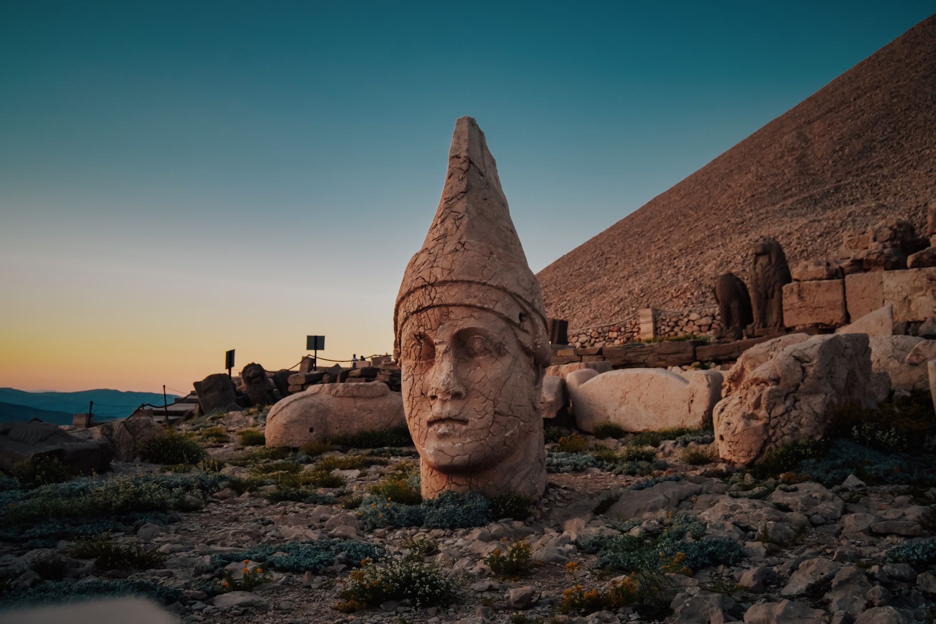 Nemrut Dağı'ndaki devasa taş heykel başlarının şafak vakti görünümü, gömülü bir mezar odasına işaret ediyor.