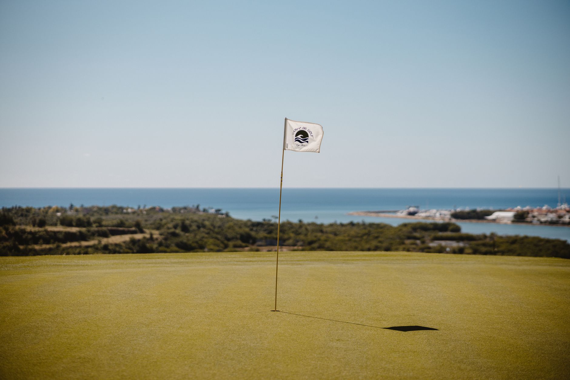 Golf flag on green fairway overlooking the ocean at Belek, Turkey.