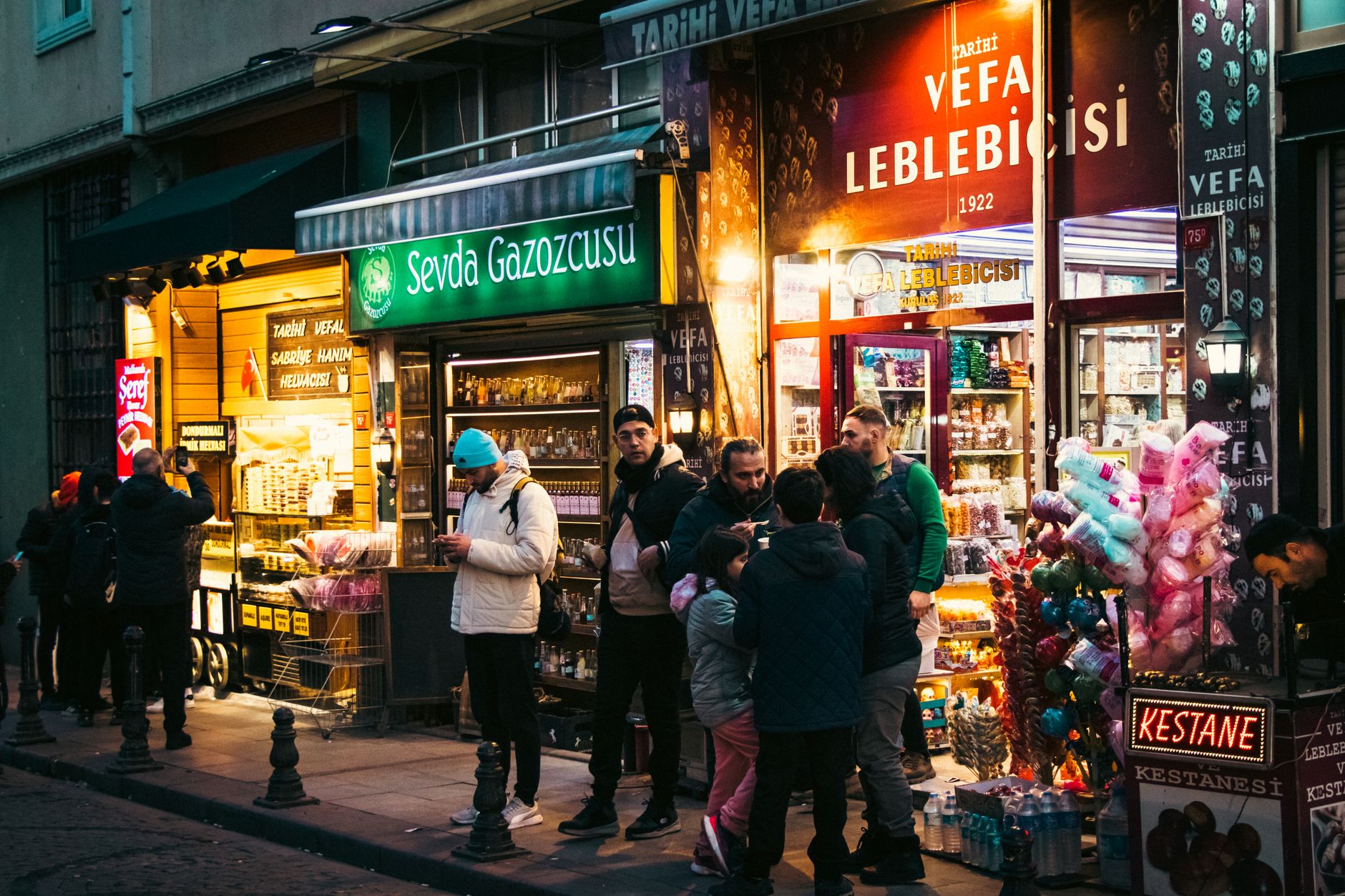 A traditional vendor at Vefa Bozacısı in Istanbul, pouring boza into a glass.