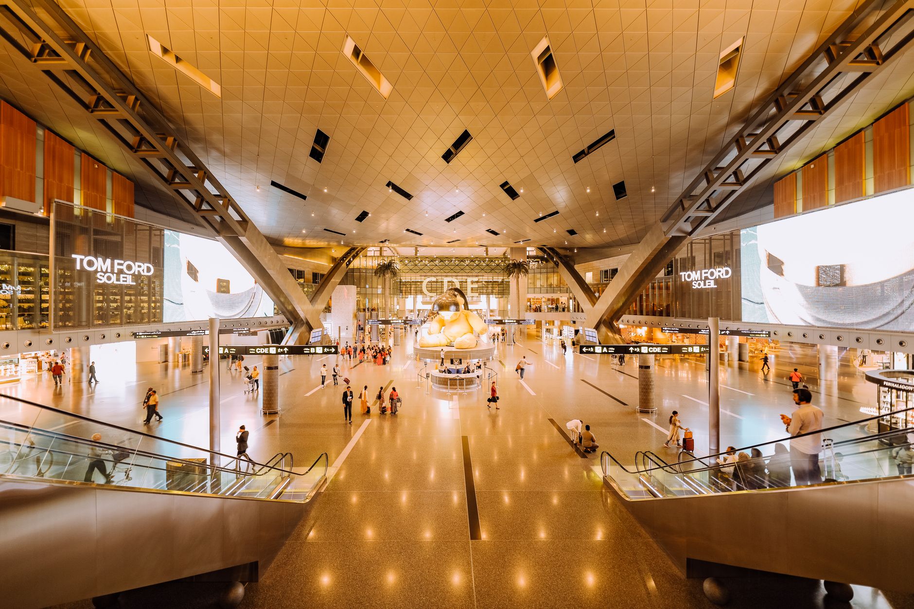Interior view of Hamad International Airport in Doha with expansive design and installations.