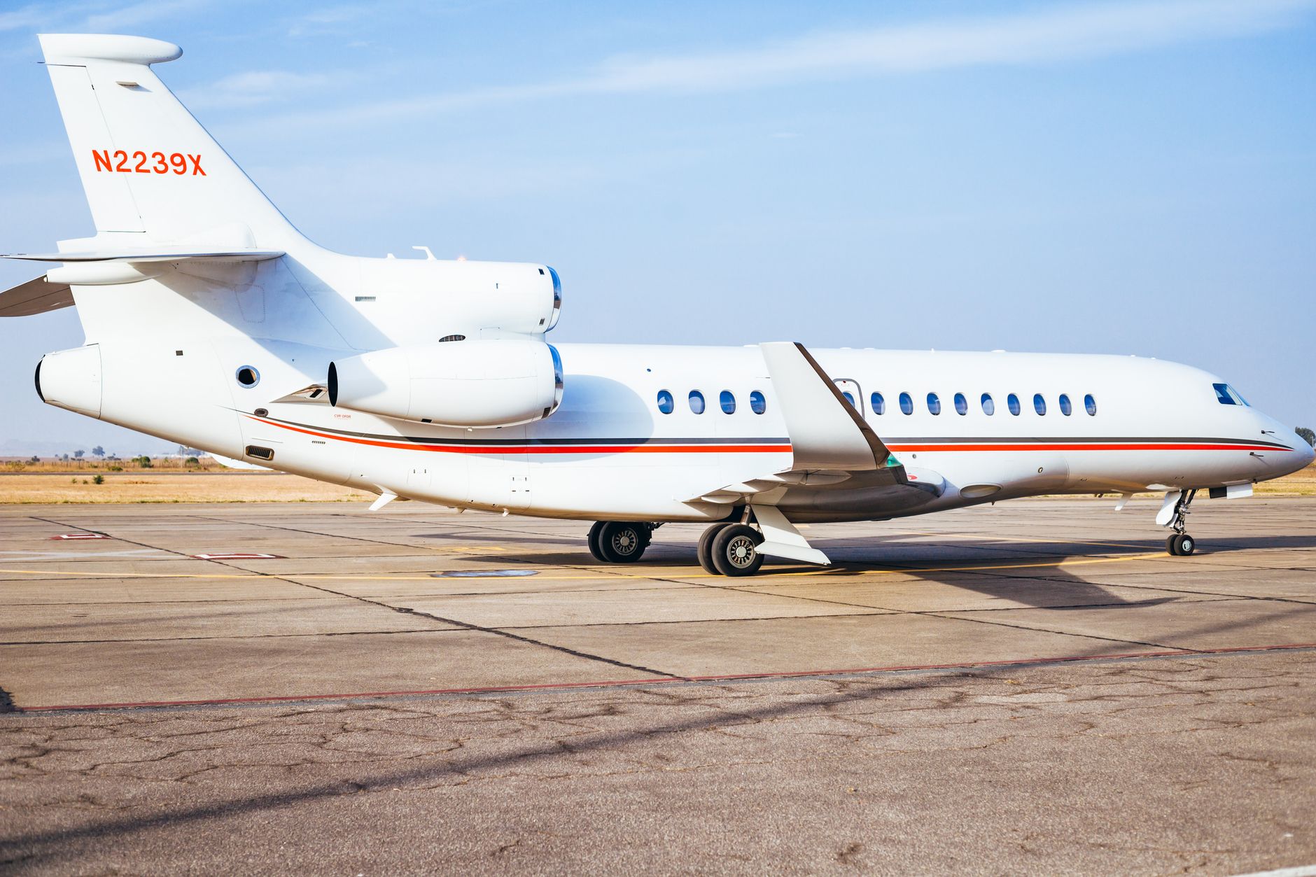 A private jet marked N2239X parked on the runway, ready for medical transfer.