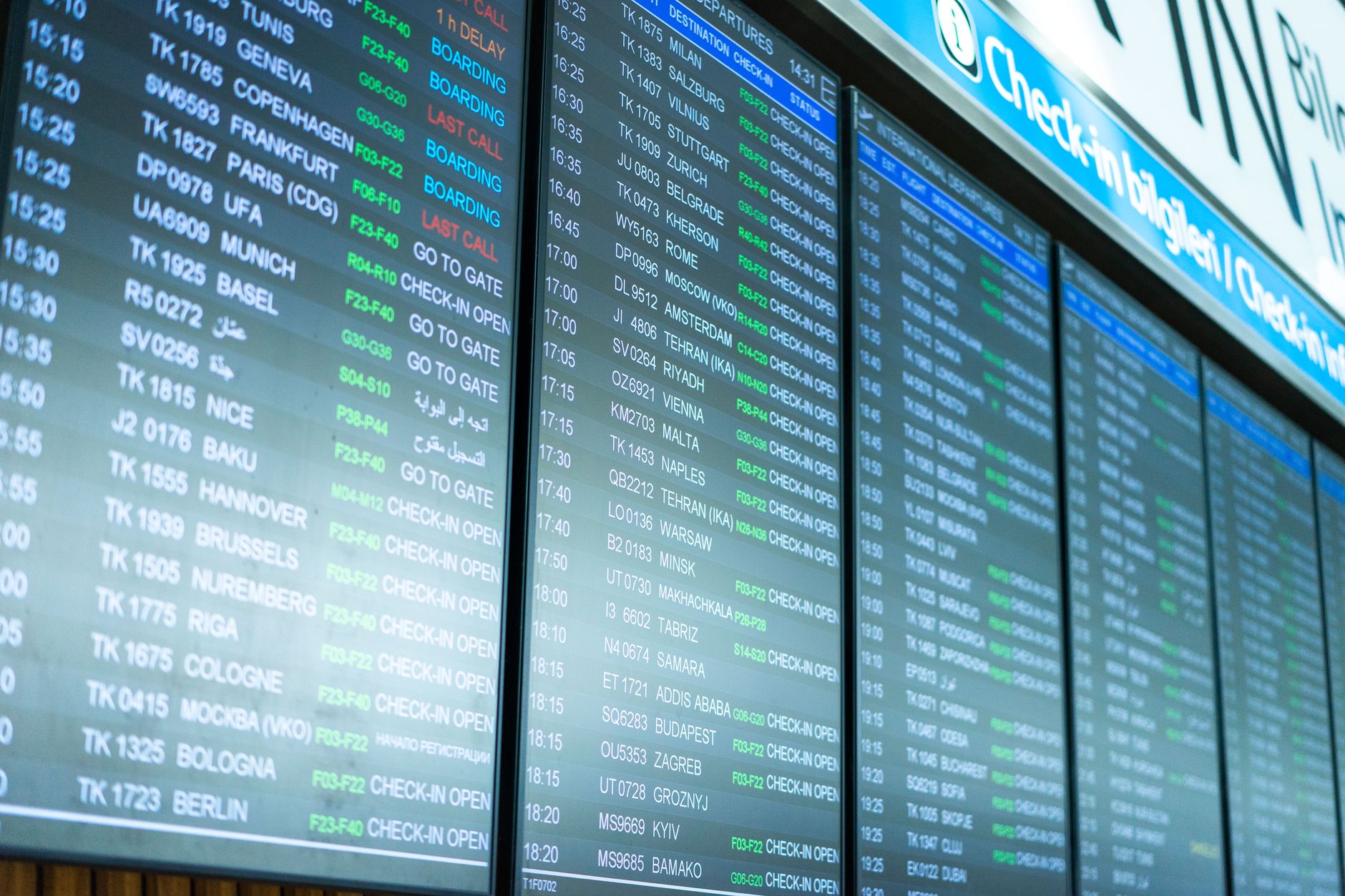 Digital flight schedule board showing various departure times and destinations.