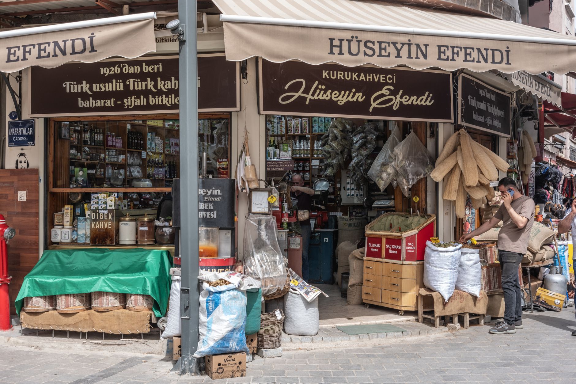 Exterior view of Kurukahveci Mehmet Efendi coffee shop in Eminönü, Istanbul, showcasing spices and coffee.