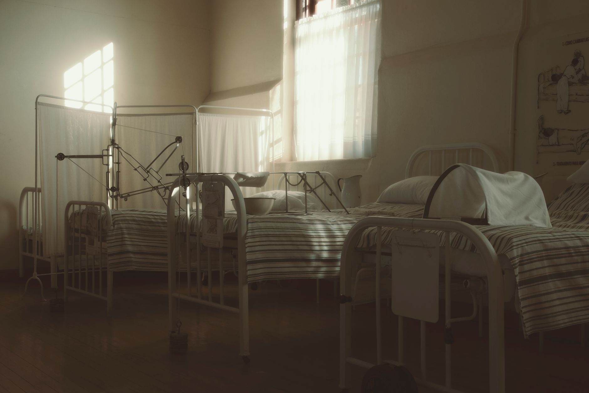 A hospital room featuring a patient's bed and a fold-out companion bed, ideal for family accommodation.